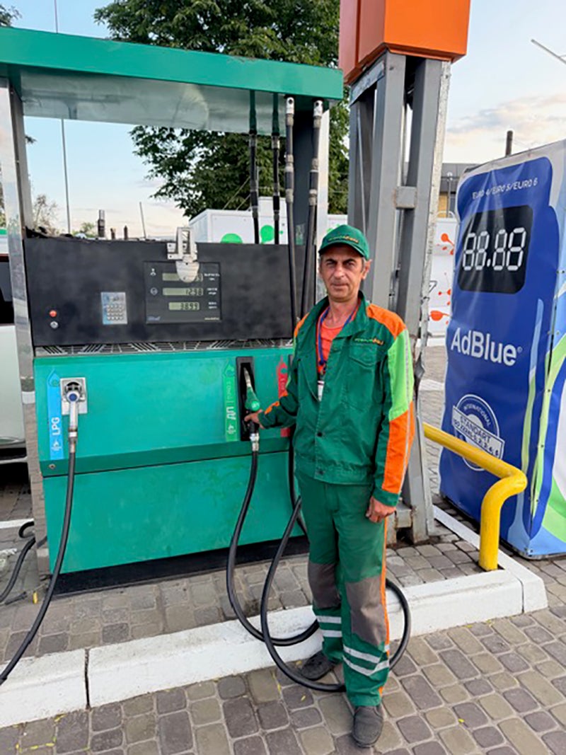 Sergei, 59, a pump attendant, points to shrapnel marks on the kiosk: ‘I look at the sky all day’