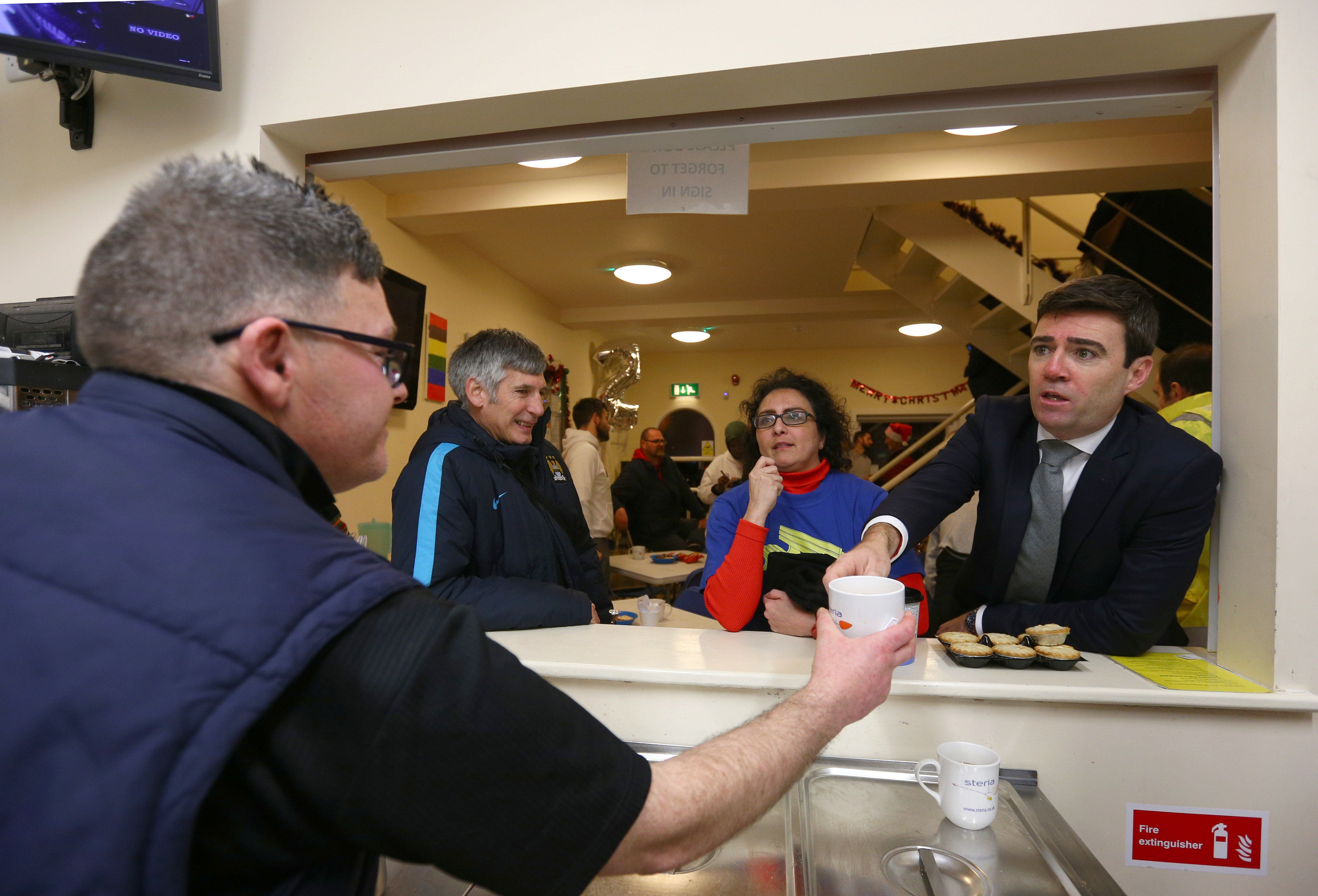 Mr Burnham, right, during a visit to the Barnabus Centre in Manchester in 2016