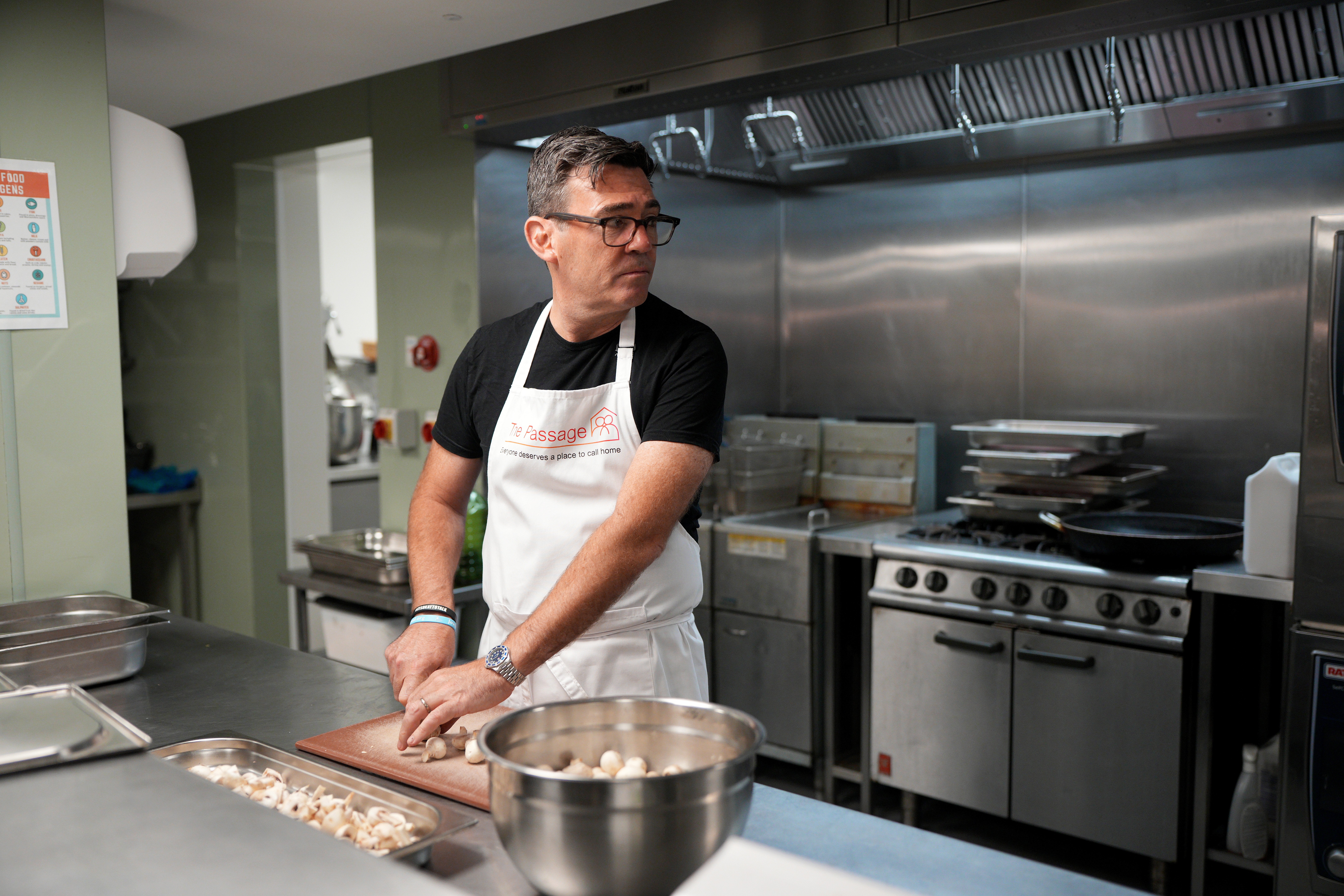 Andy Burnham helps prepare breakfast during his visit to The Passage Homeless Charity in London on Monday