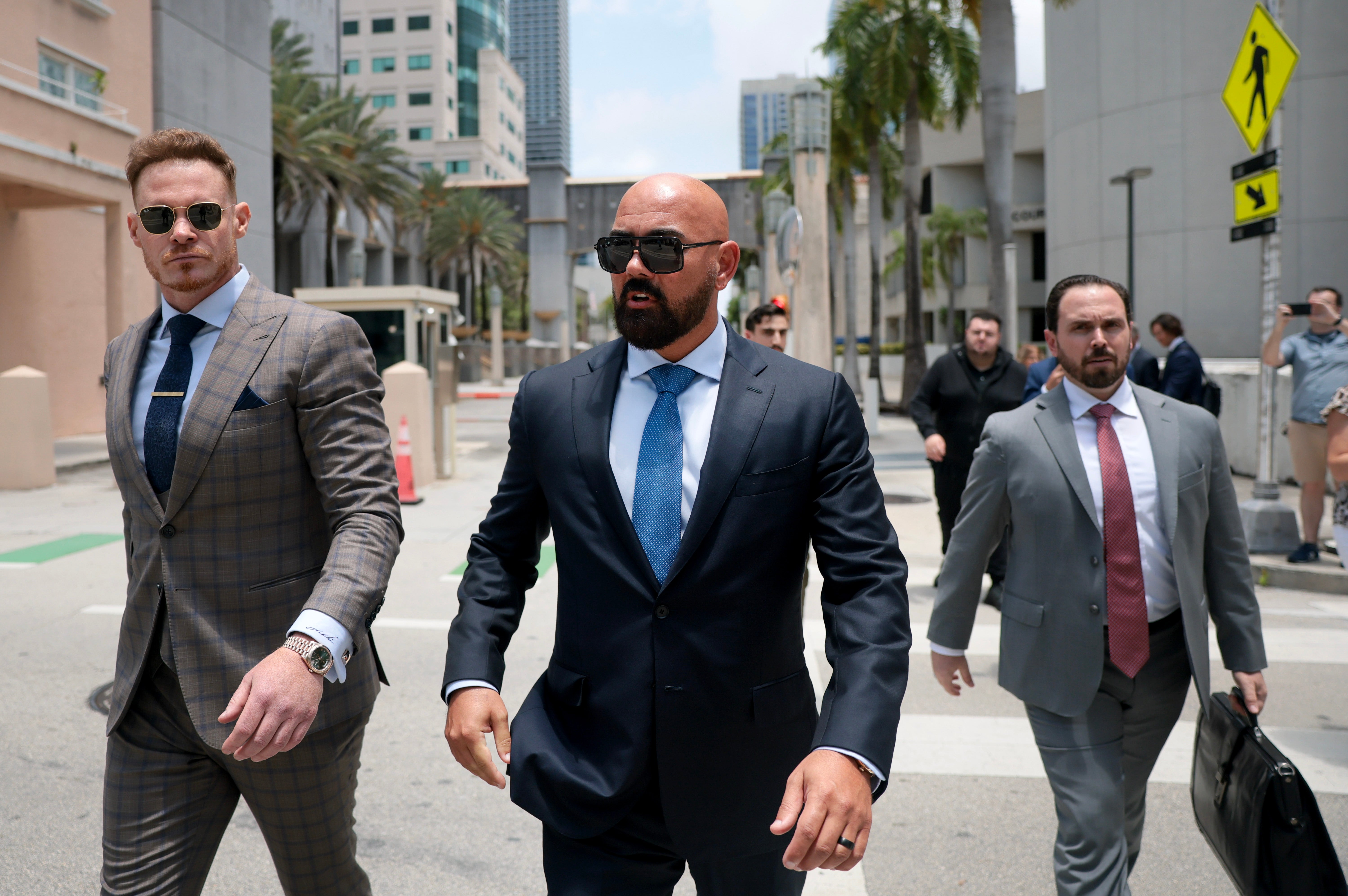 Joseph McBride (C), lead counsel for Andrew and Tristan Tate, along with Justin Waller (L), a friend of the brothers, and Thomas Maniotis (R), co-counsel, exit the C. Clyde Atkins United States Courthouse (Getty)