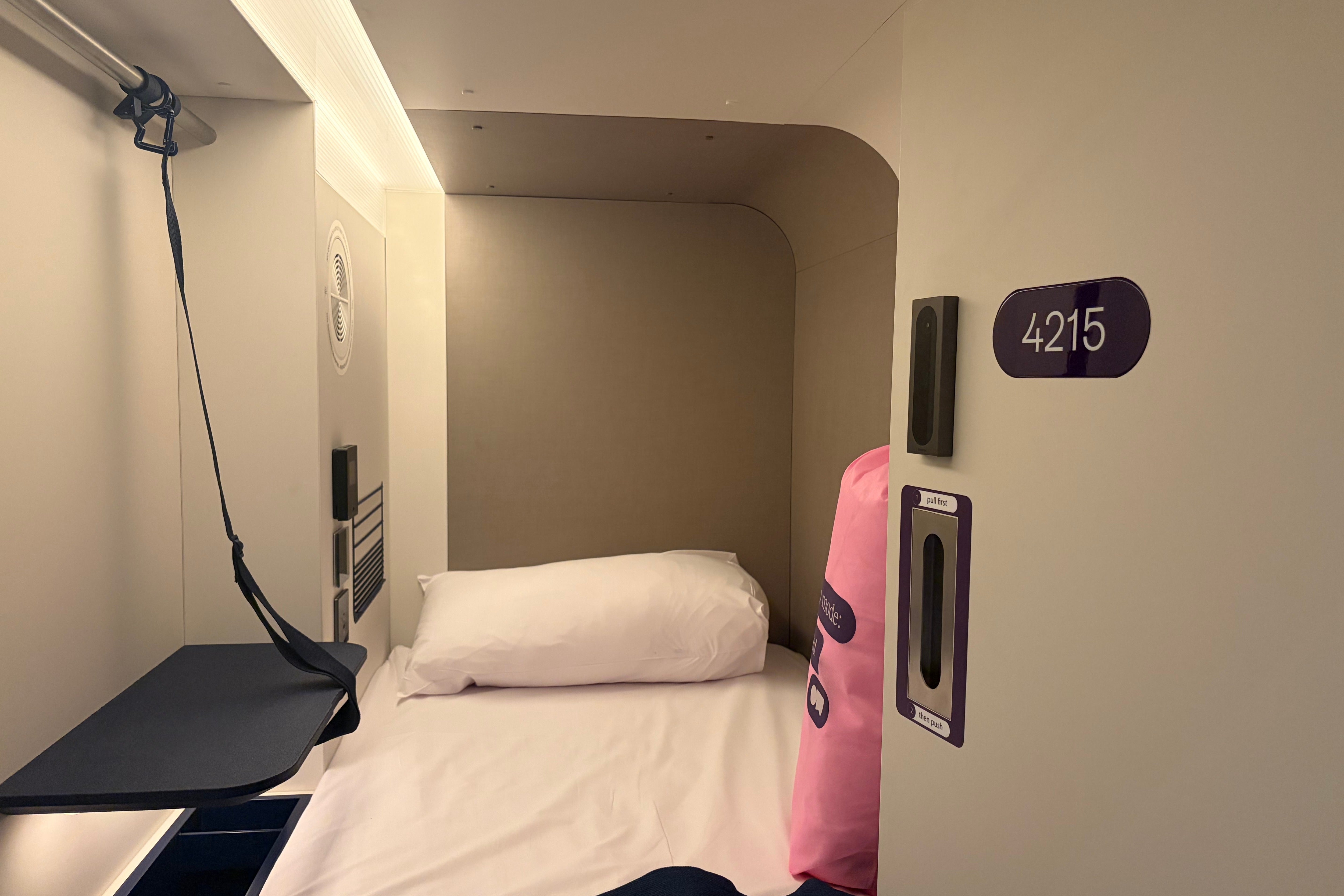 A single capsule bed at Otherwander pod hotel (Jacqui Merrington/The Independent)