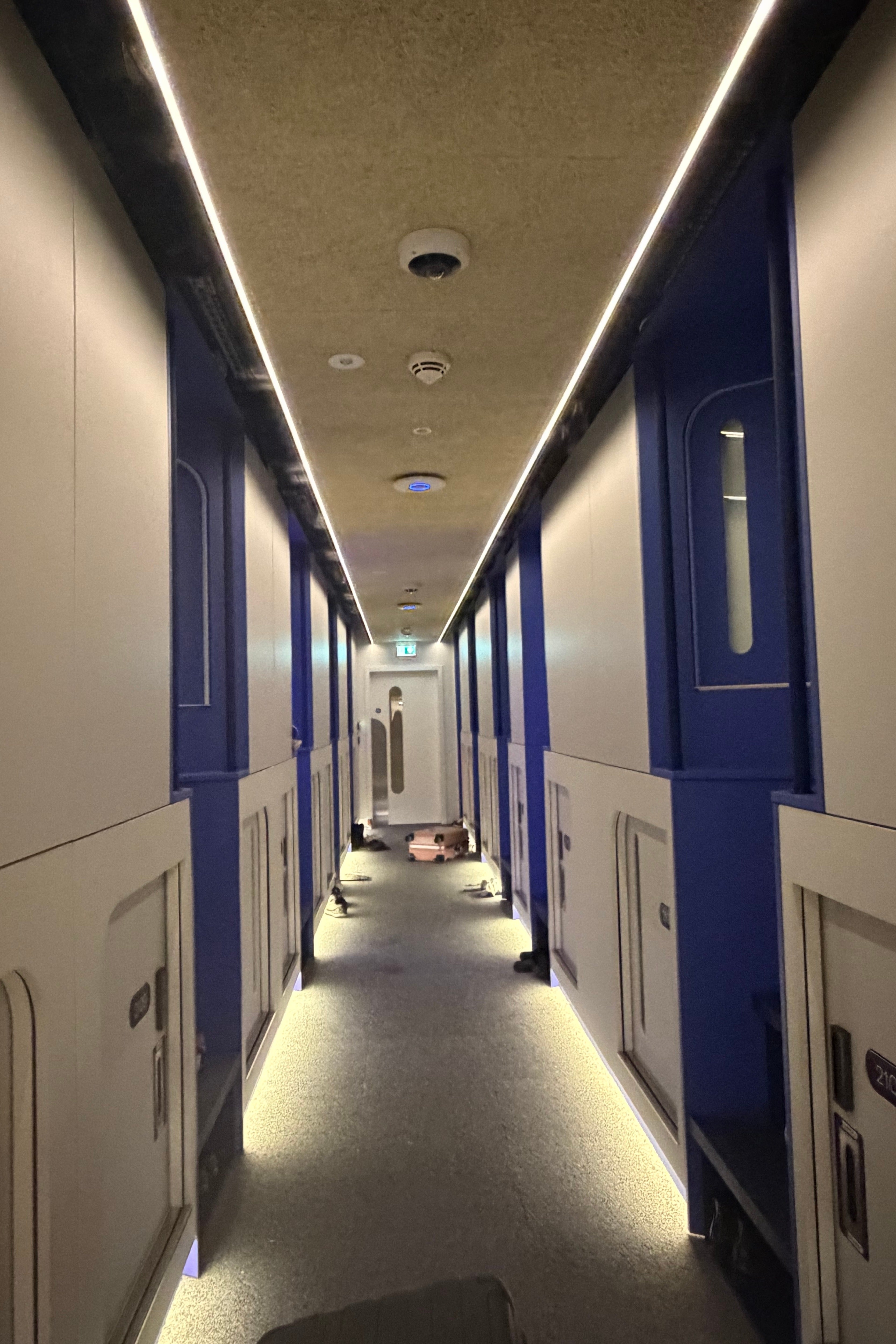 The corridor of tiny capsule doors at Otherwander (Jacqui Merrington/The Independent)