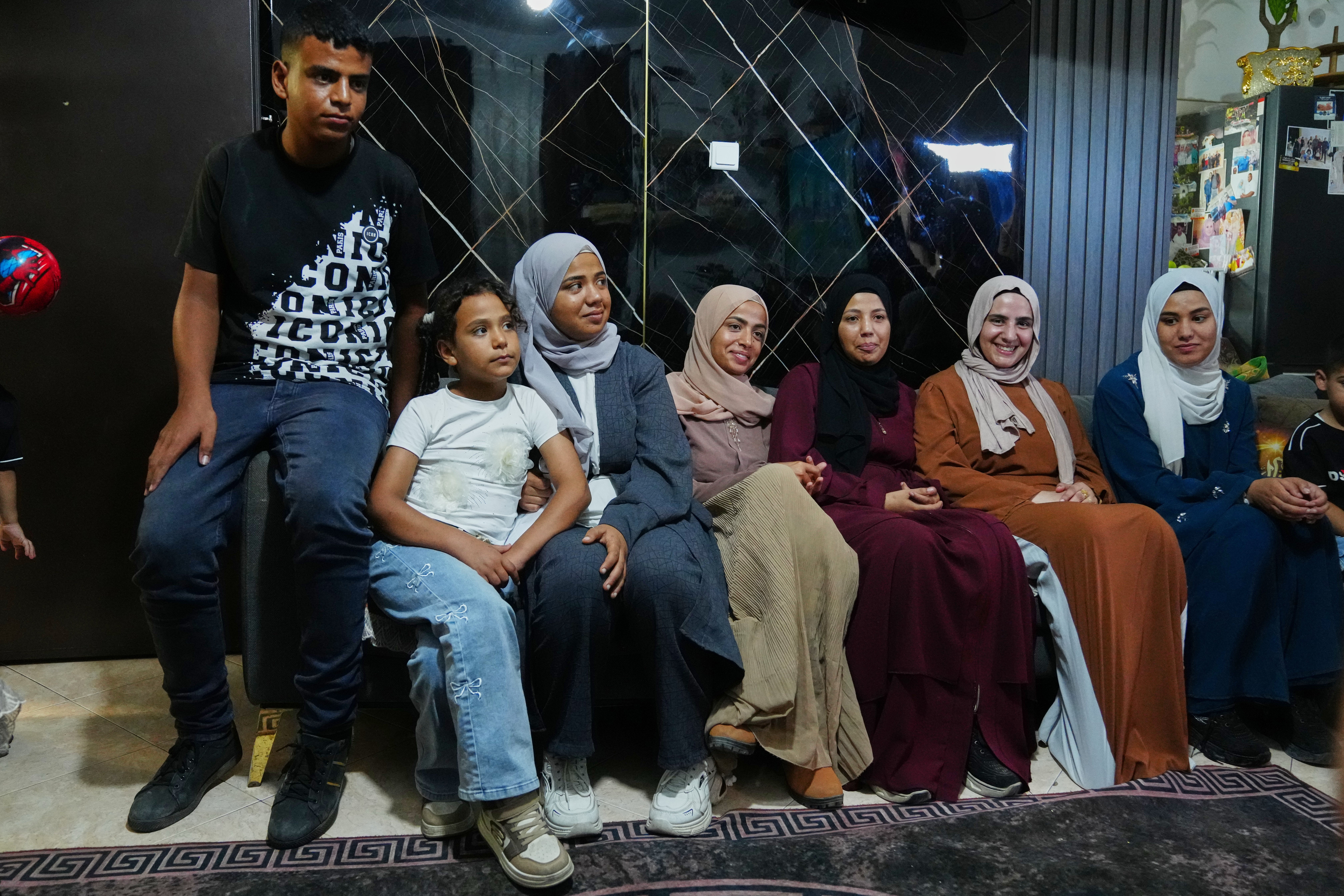Mais Al-Gharam, second from right, poses for a photo with her six siblings from Gaza, who were granted Israeli passports, in her home in Nazareth, Israel, Wednesday, July 8, 2026. (AP Photo/Mahmoud Illean)