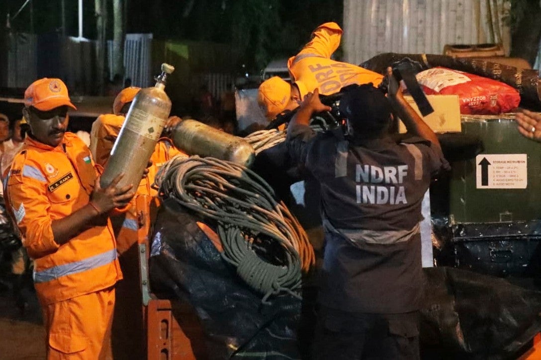 National Disaster Response Force personnel prepare for a rescue operation at the site of a collapsed tunnel at Samardung village of Sikkim, India (AP)