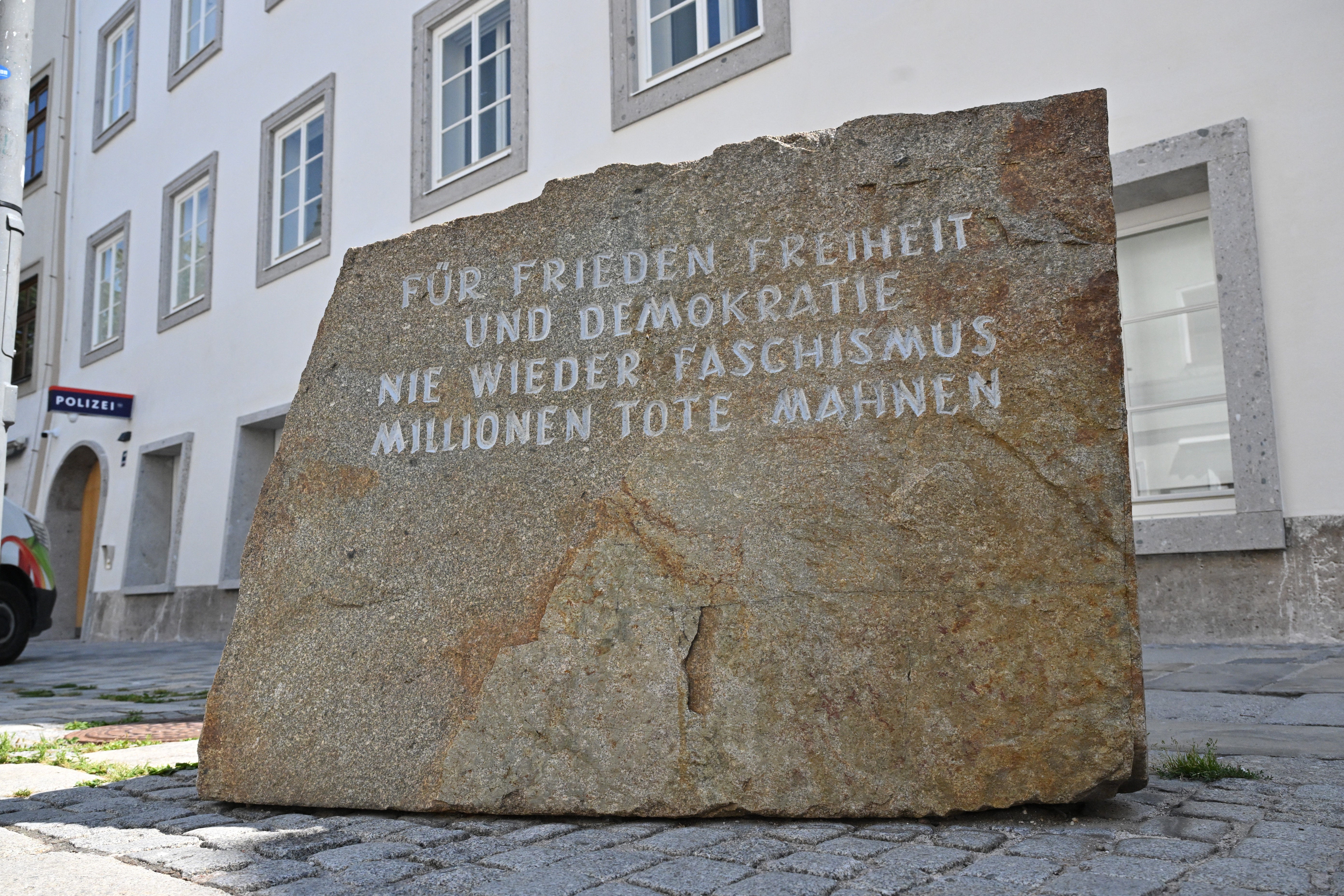 A sign outside the house says: &rsquo;For peace in freedom and democracy. Never again fascism. Millions of dead are a warning&rsquo; qhxidiqxkiqxzinv