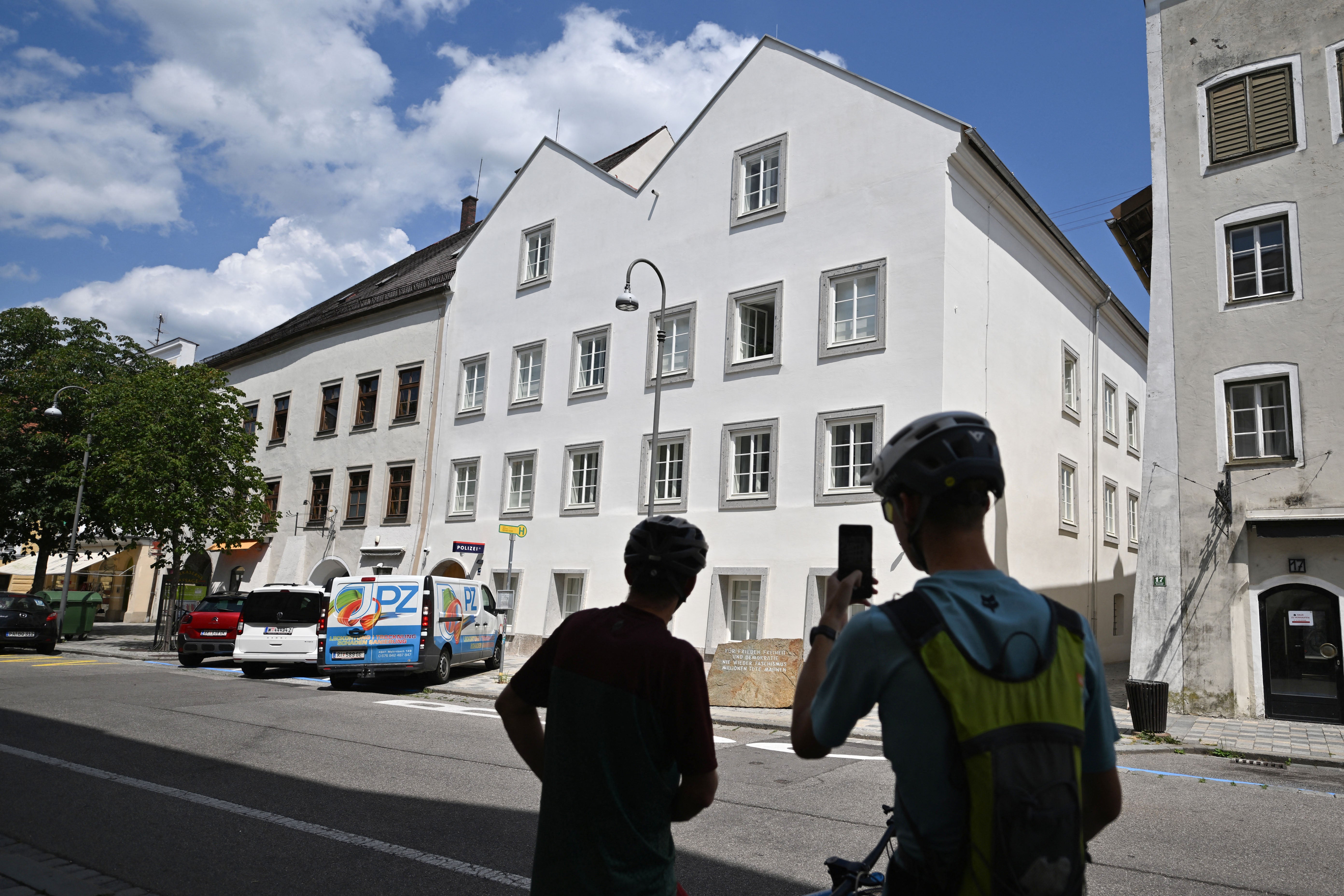 Tourists take a photo of the house where Nazi dictator Adolf Hitler was born