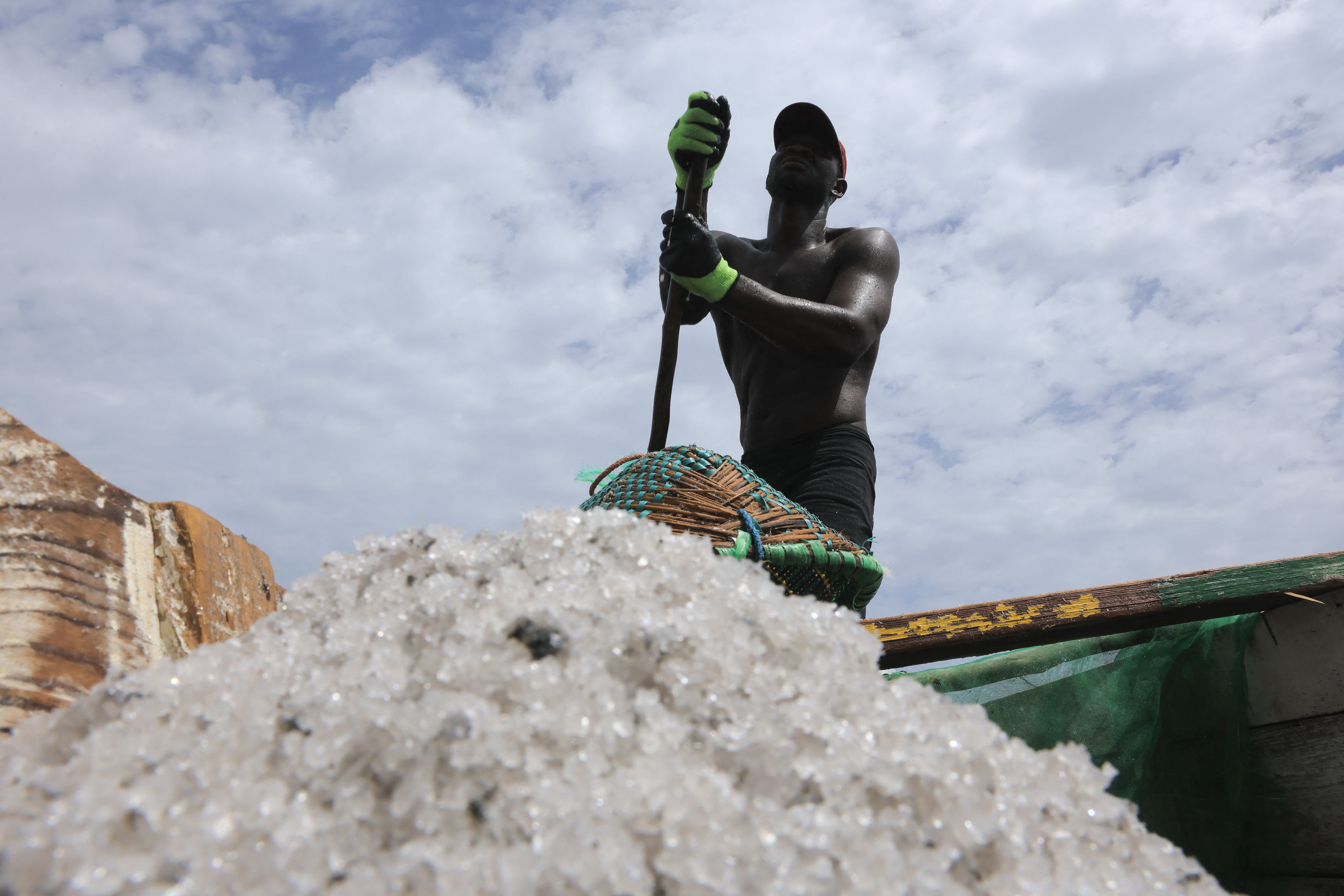 Seydou Toure, 45, a salt extractor, steers his pirogue filled with salt extracted from the Pink Lake (Lac Rose), officially known as Lake Retba, near Dakar, Senegal,