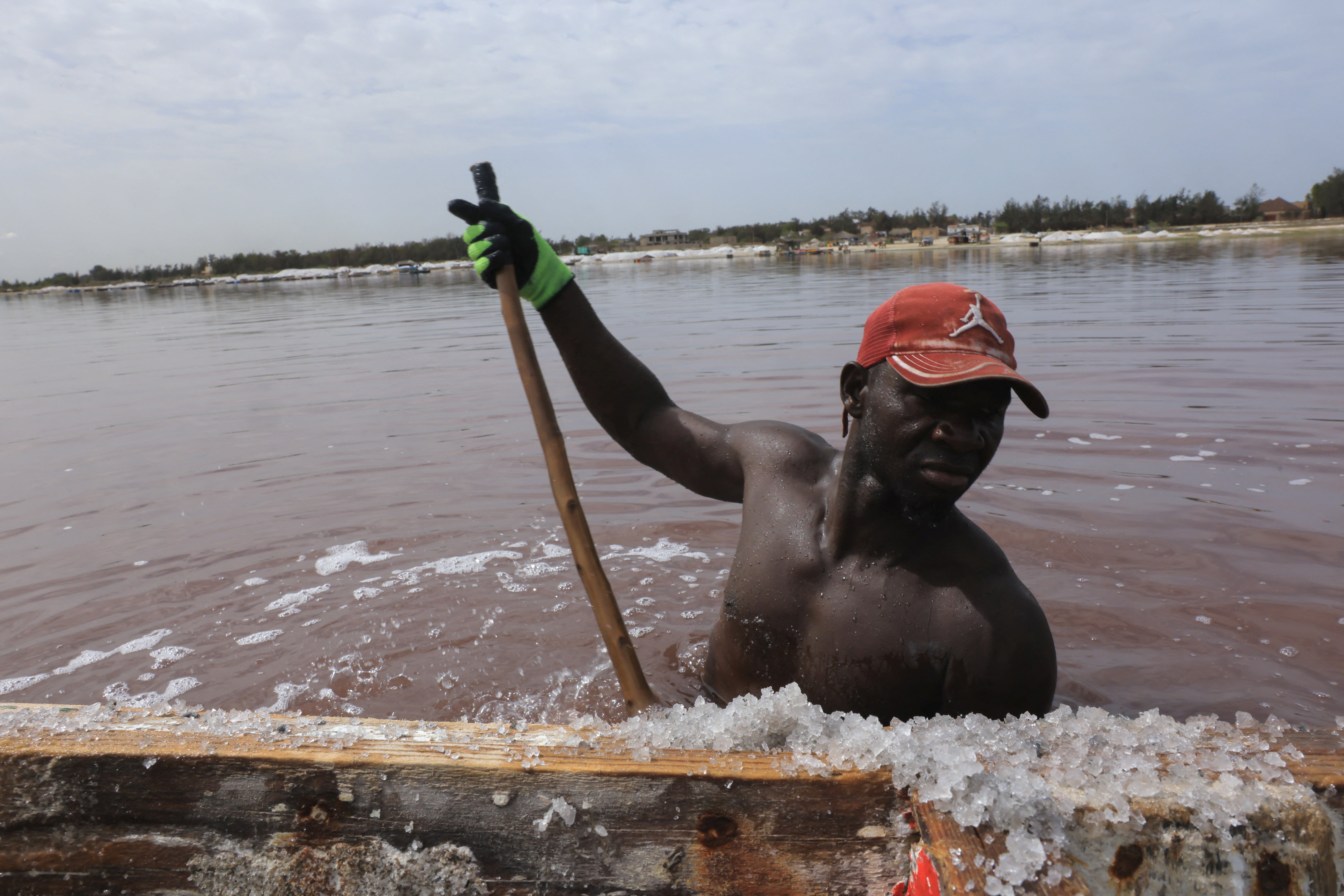 Seydou Toure, 45, a salt extractor, extracts salt from the Pink Lake (Lac Rose), officially known as Lake Retba, near Dakar, Senegal, June 24, 2026. REUTERS/Raghed Waked