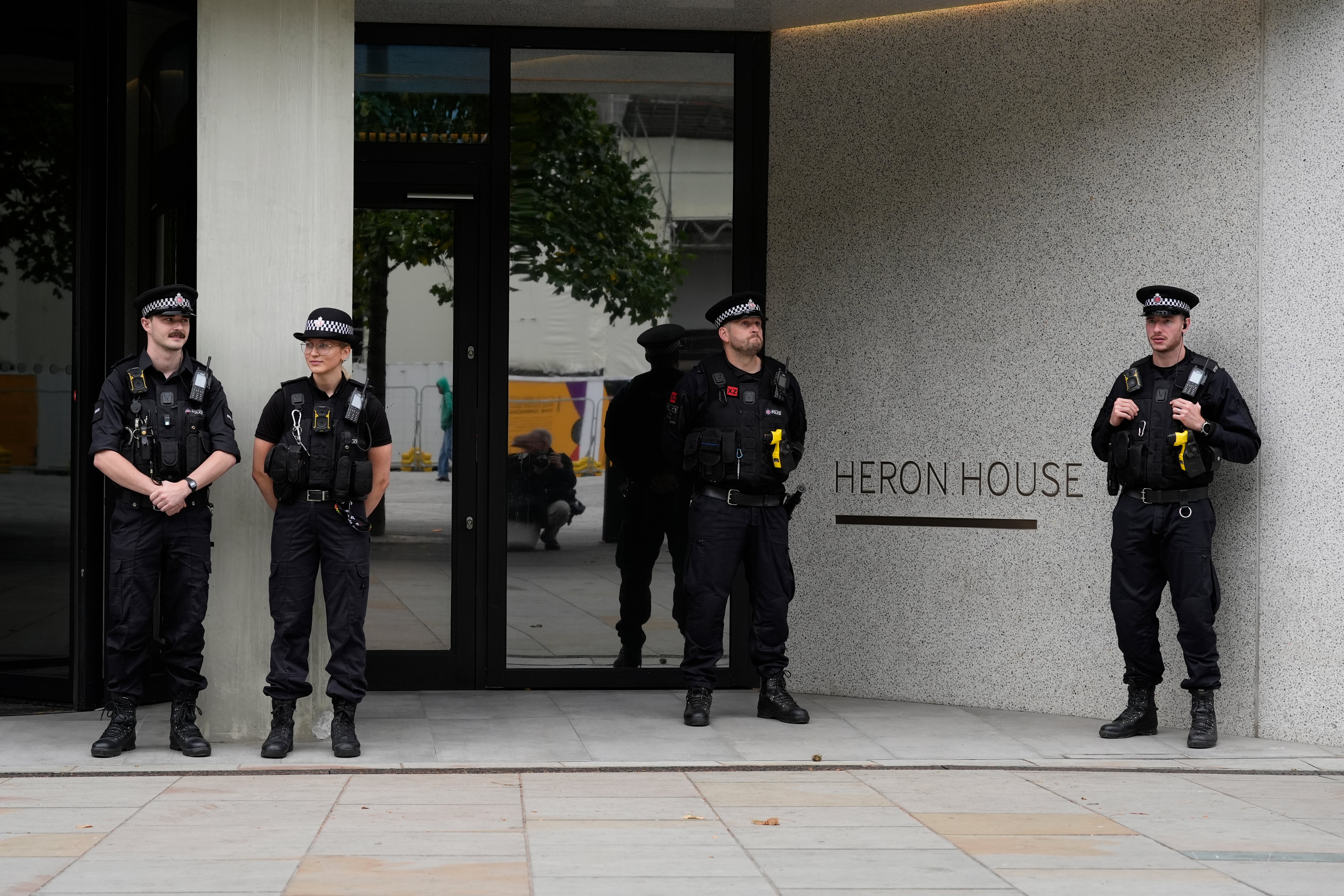 Police officers outside No 10 North, located in Heron House, central Manchester (PA)