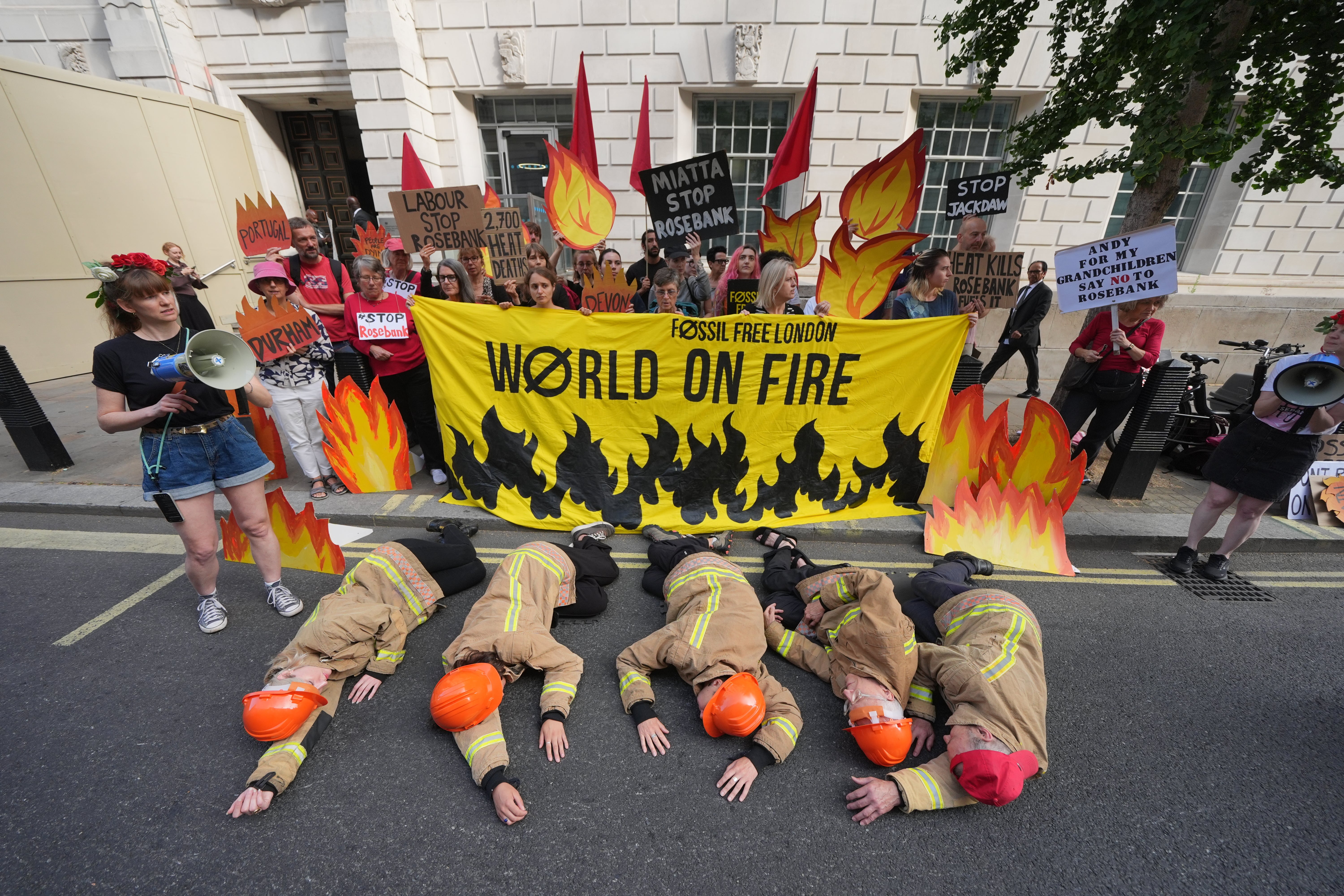 Campaigners dressed as firefighters (Yui Mok/PA)