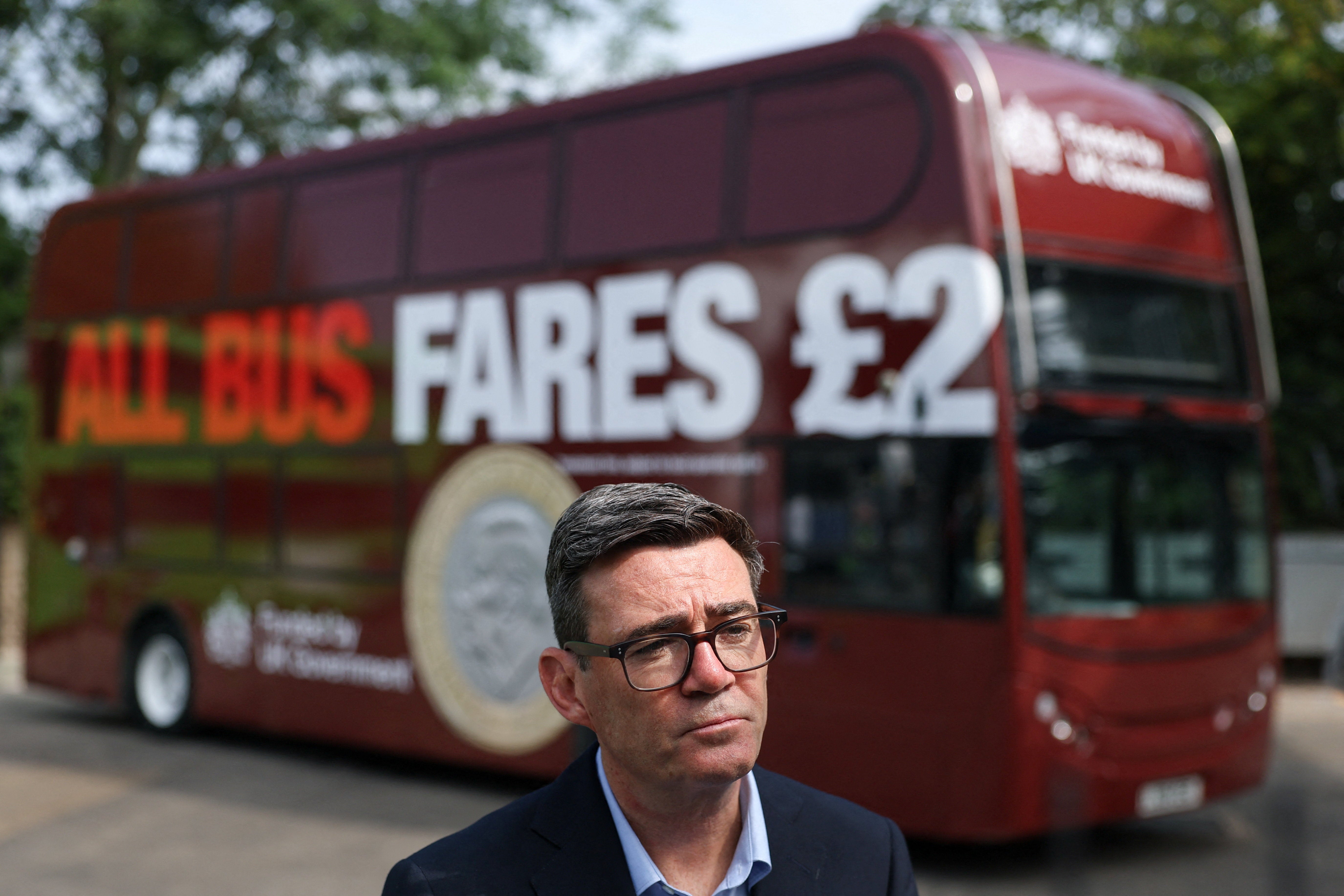 Andy Burnham looks on in front of a FirstGroup bus at the bus station during an interview, as he announces a £2 cap on bus fares in England (Getty)