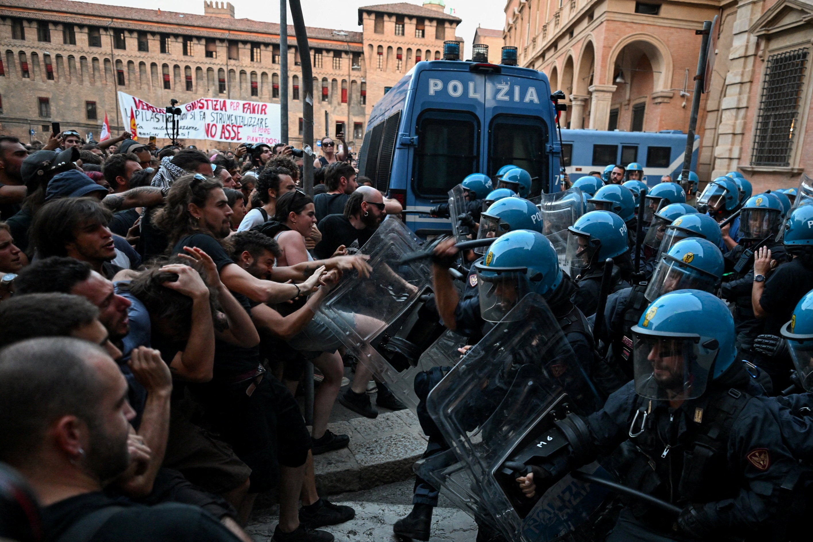 Protesters clash with riot police during a protest following the death of Abderrahim Fakir after he was restrained by police during an attempted detention, in Bologna, Italy, July 20, 2026.