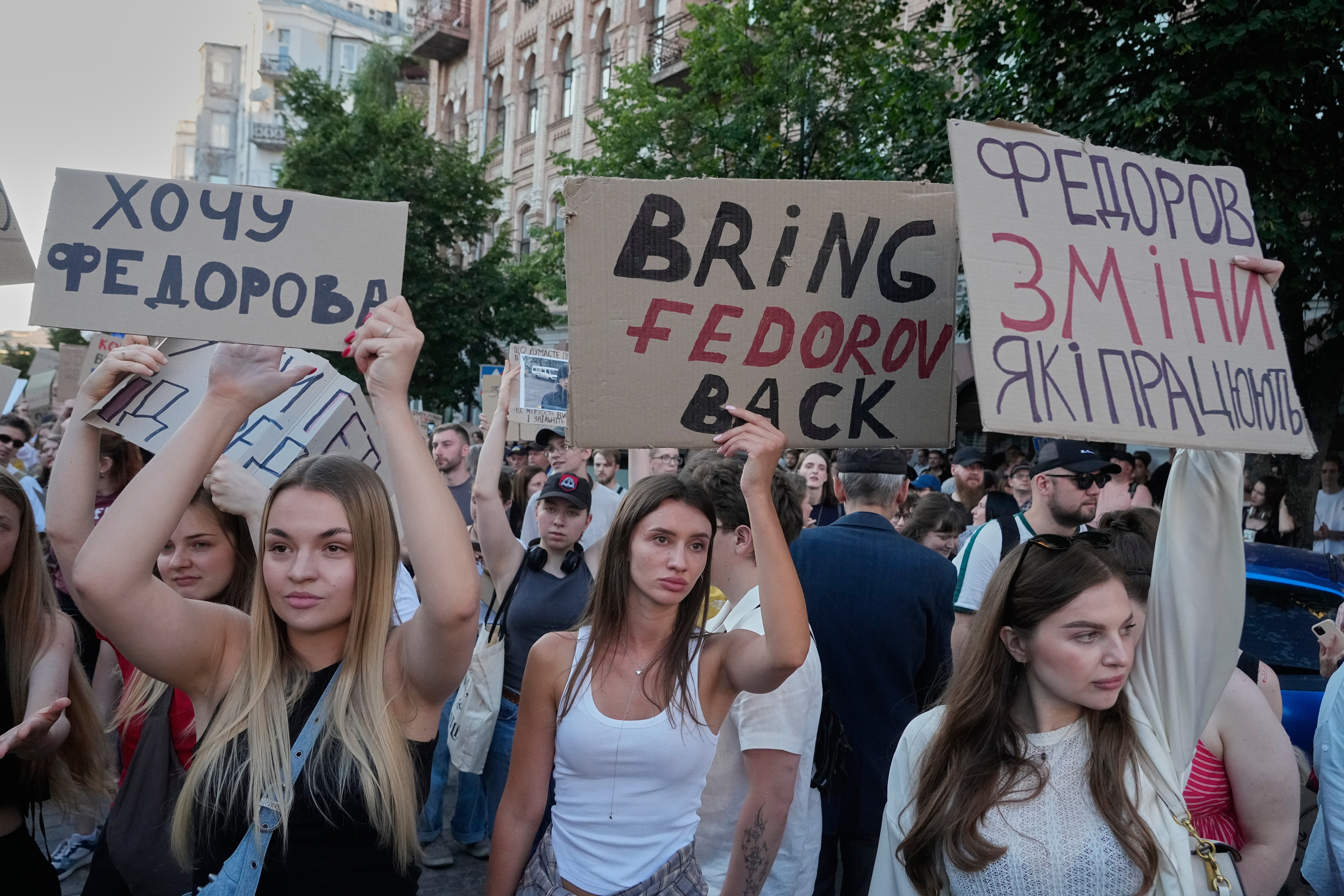 Activists shout slogans during a rally to denounce President Volodymyr Zelensky's decision to dismiss Defense Minister Mykhailo Fedorov after six months in the post, Friday, July 17