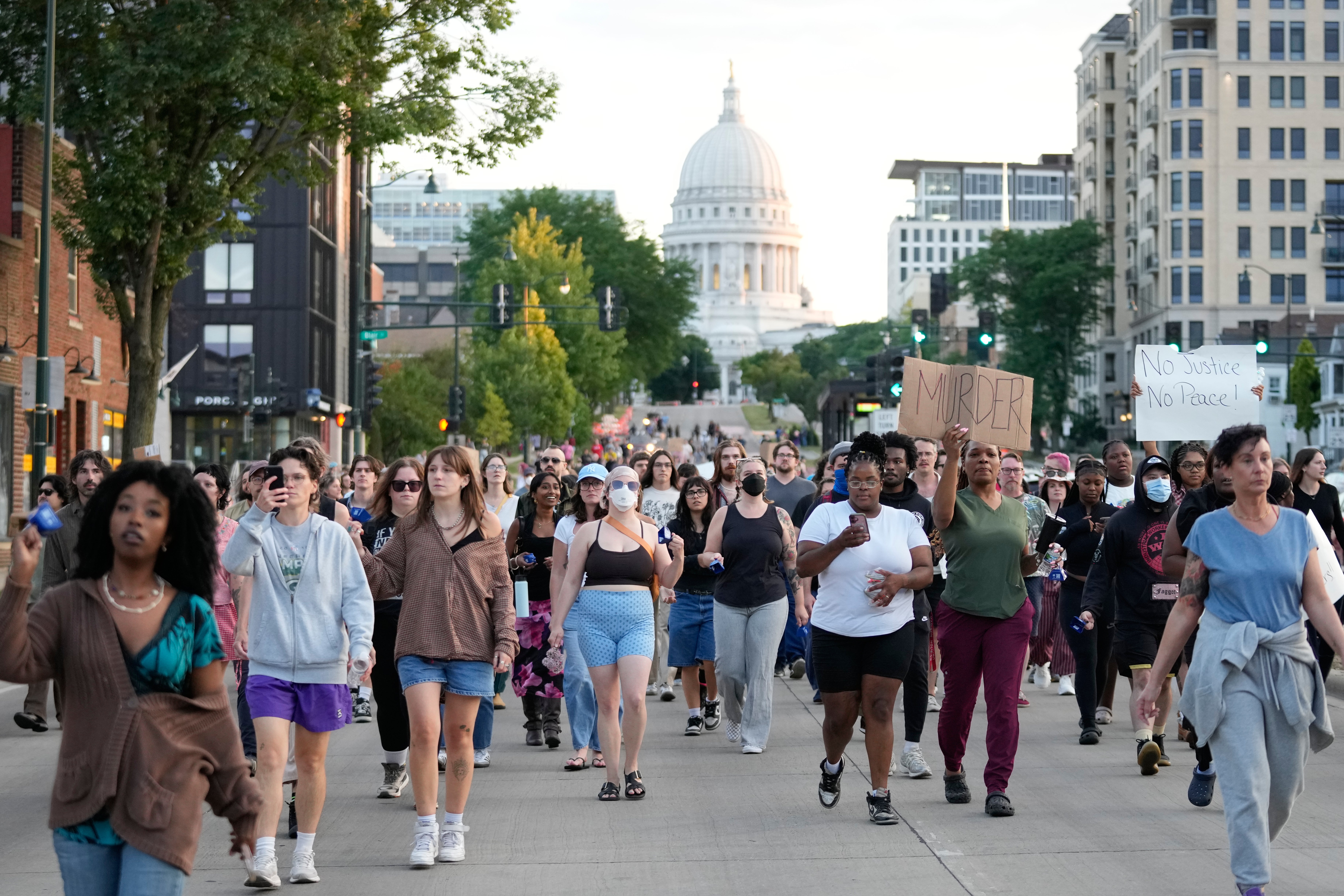 Protesters march close to the Capitol building in downtown Madison