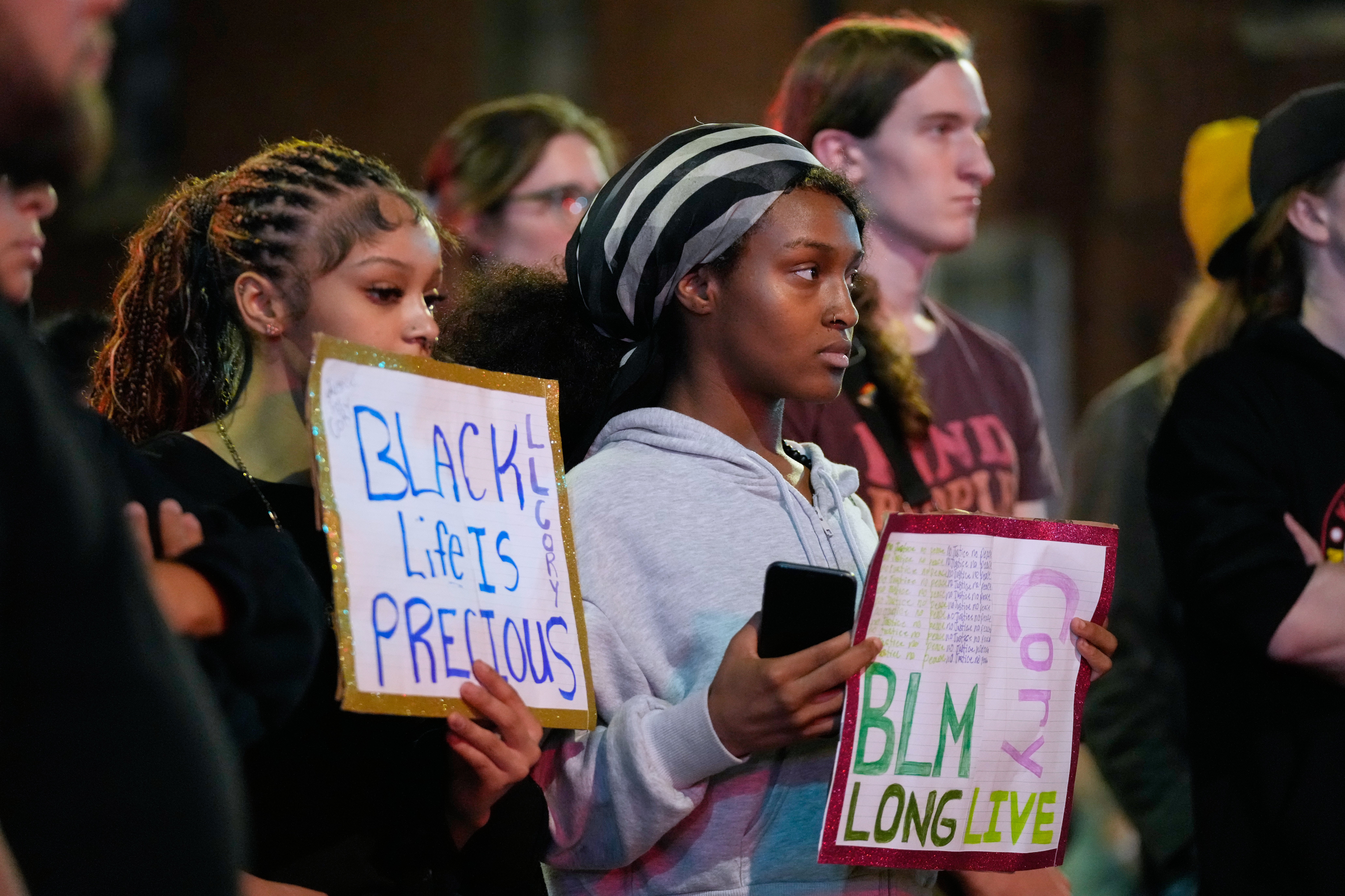 Attendees gather at a candlelight vigil where a Madison police officer shot and killed a man Wednesday, July 22, 2026