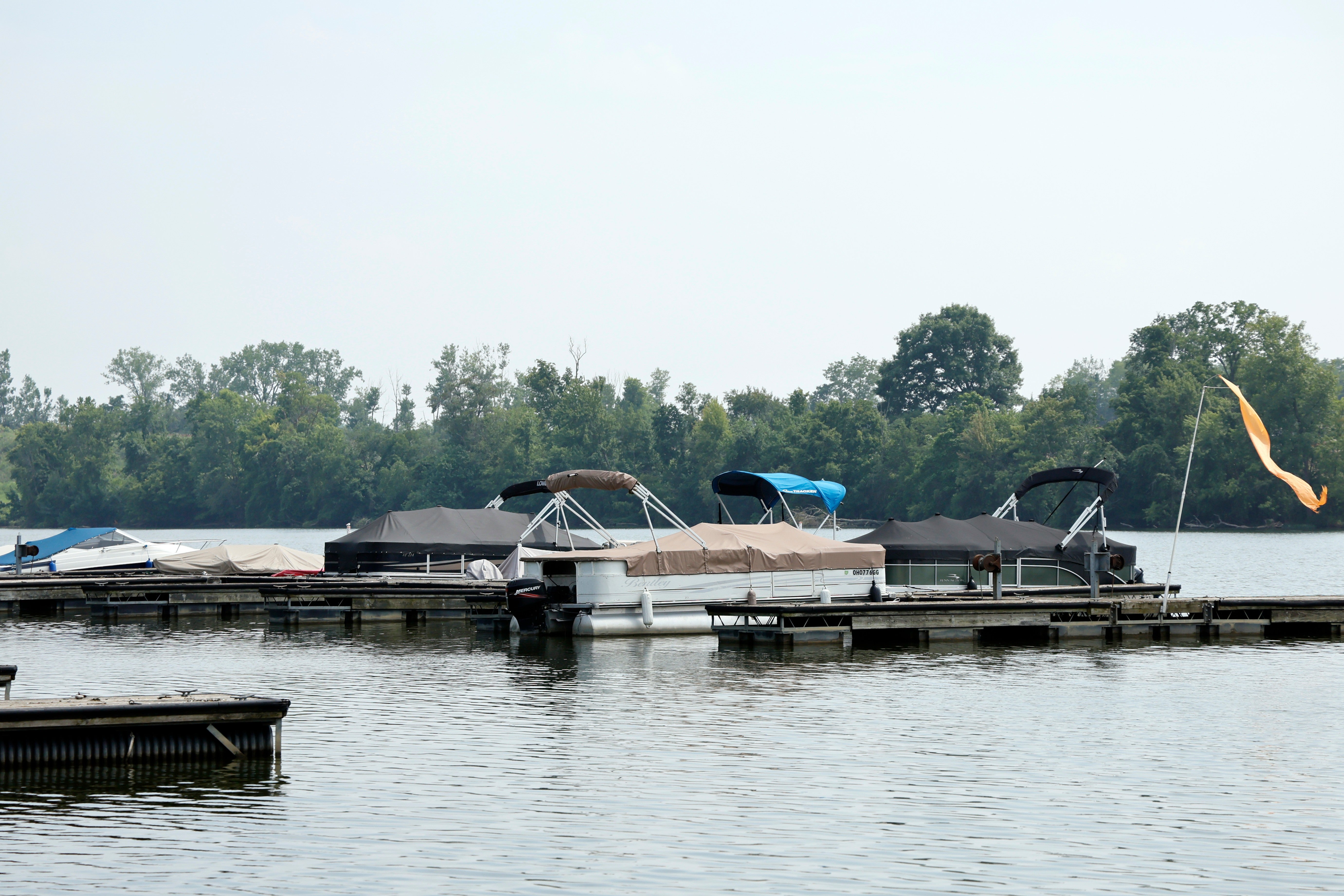Boats sit moored on the Scioto River near where multiple people died after several of them went into the water to help another person who was struggling to swim