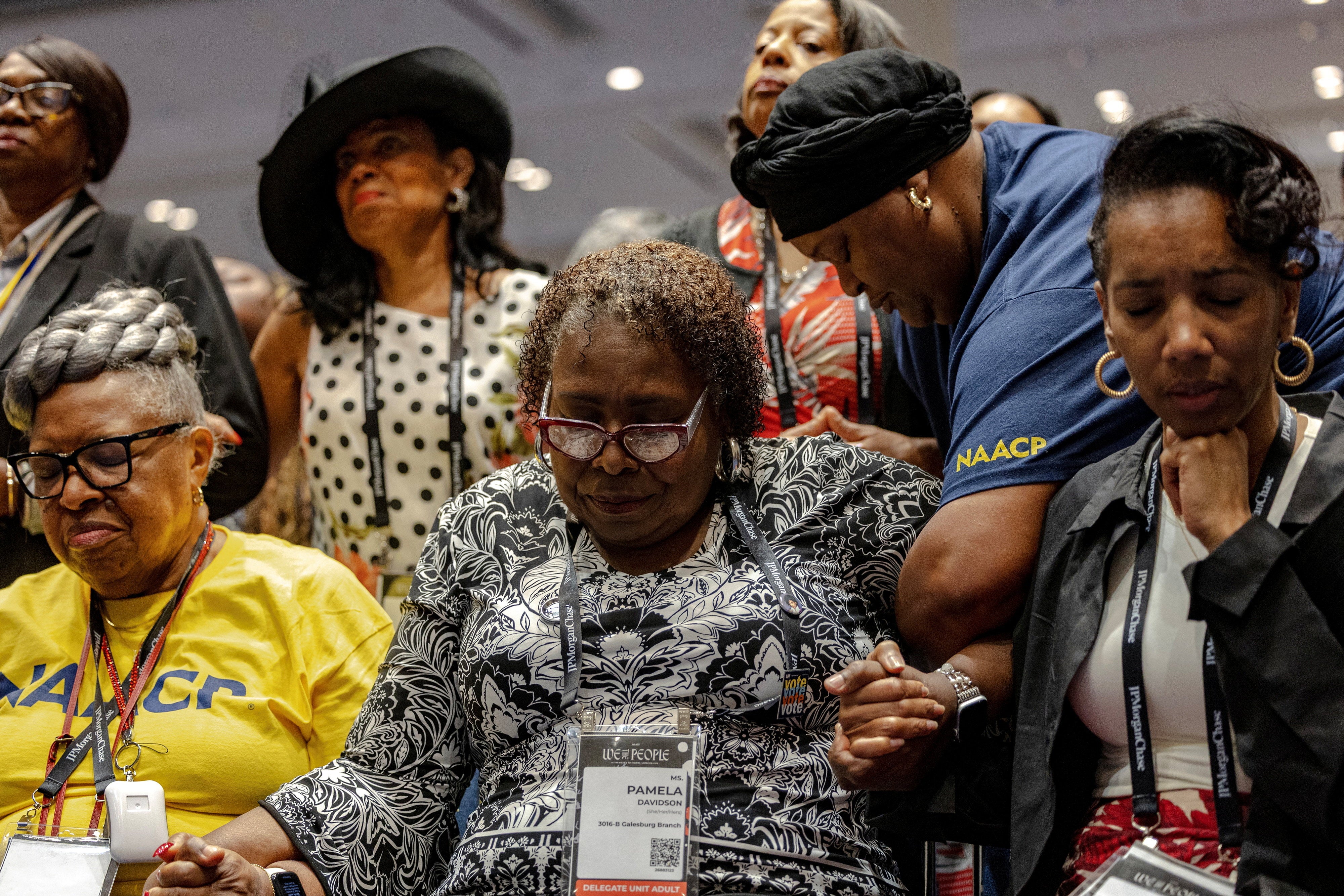 Attendees pray after Ben Crump, a lawyer for the family of Nolan Wells, announced the results of the autopsy (Reuters)