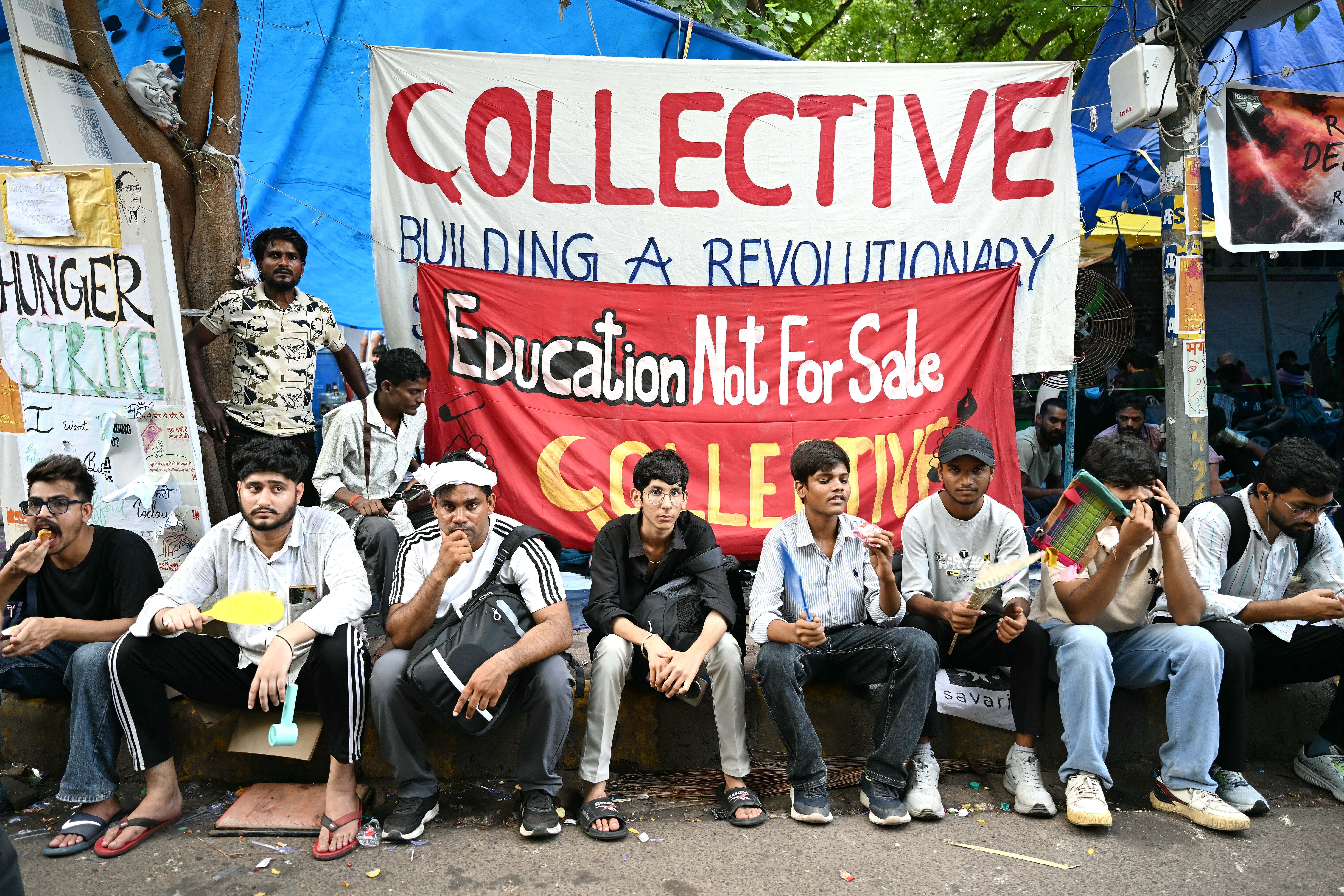 Cockroach Janta Party (CJP) supporters sit at Jantar Mantar in New Delhi on 23 July 2026 during the ongoing protest