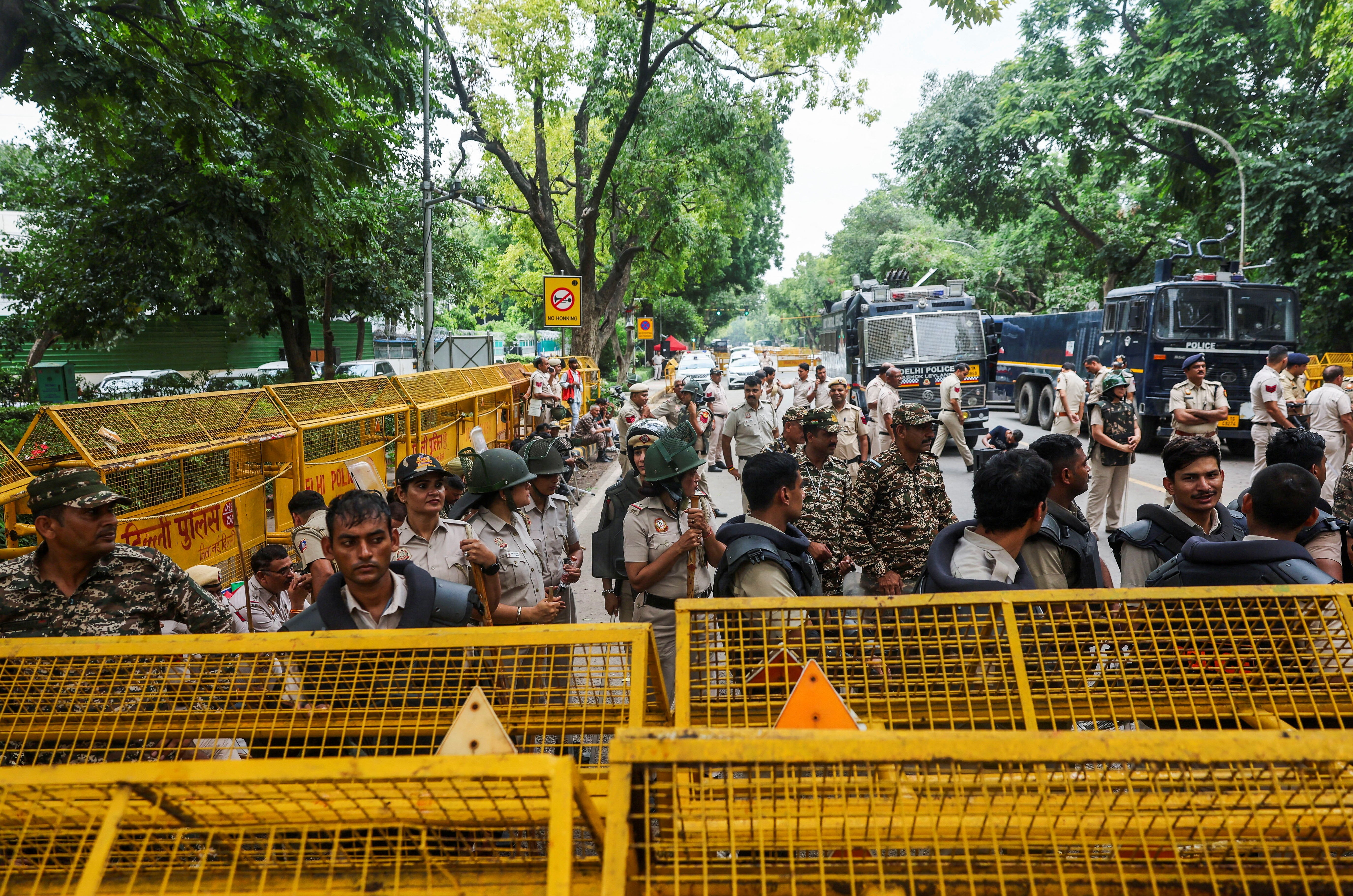 Police personnel stand guard outside Minister of Education of India Dharmendra Pradhan's residence, as supporters of India's Cockroach Janata Party (CJP) demonstrate during the ongoing protests