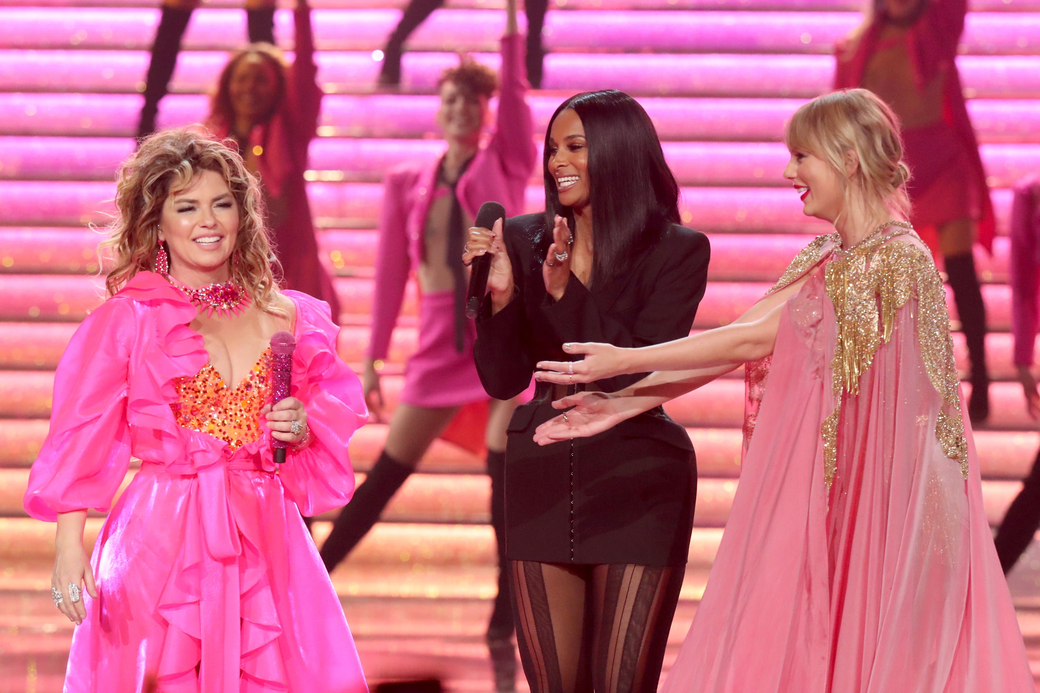 Shania Twain, left, Ciara and Taylor Swift onstage during the 2019 American Music Awards (Getty)