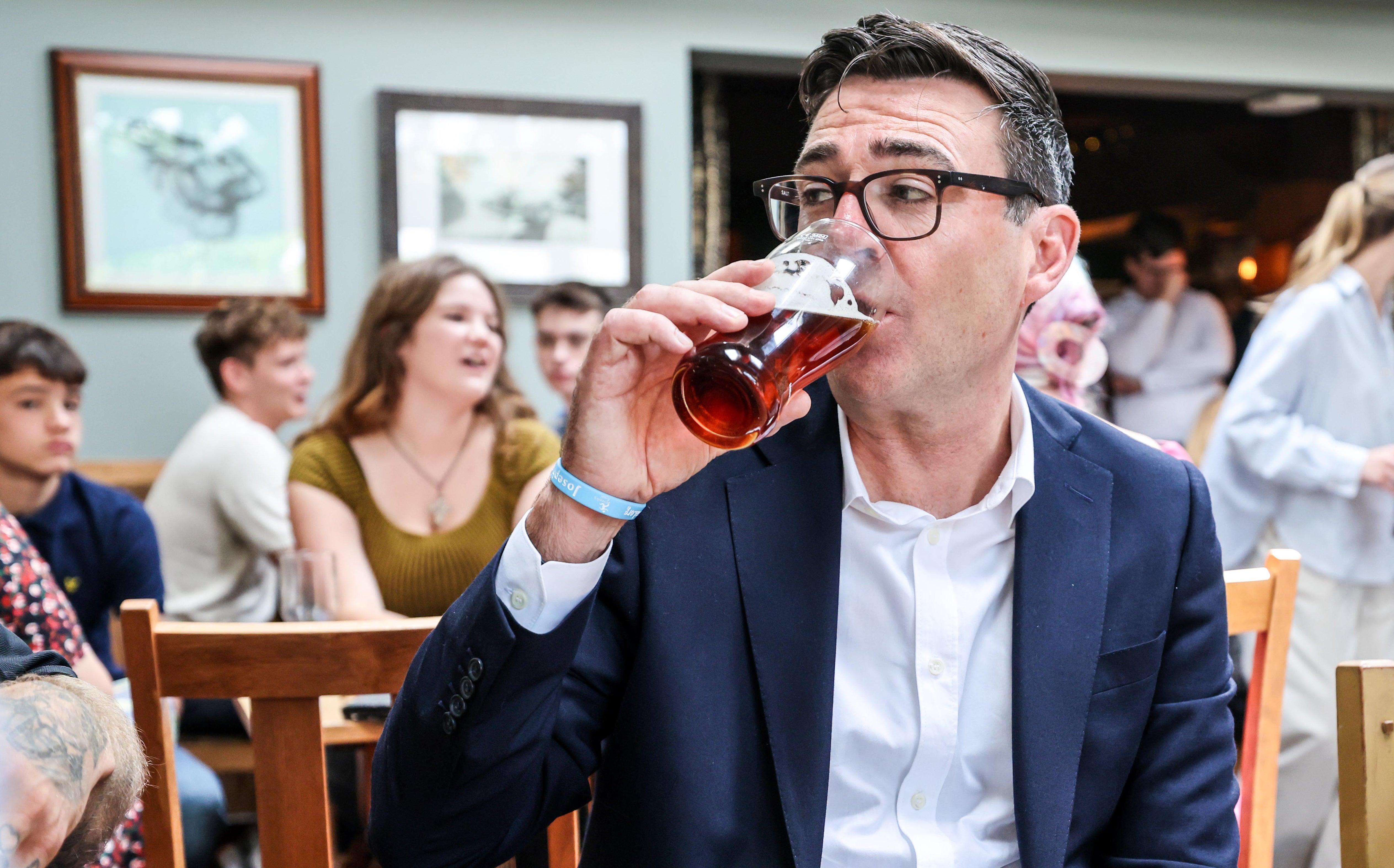Prime Minister Andy Burnham drinks a beer during a visit to the Hare pub in Harlow, Essex, to highlight the work the Government is doing to support the industry (Richard Pohle/The Times/PA)