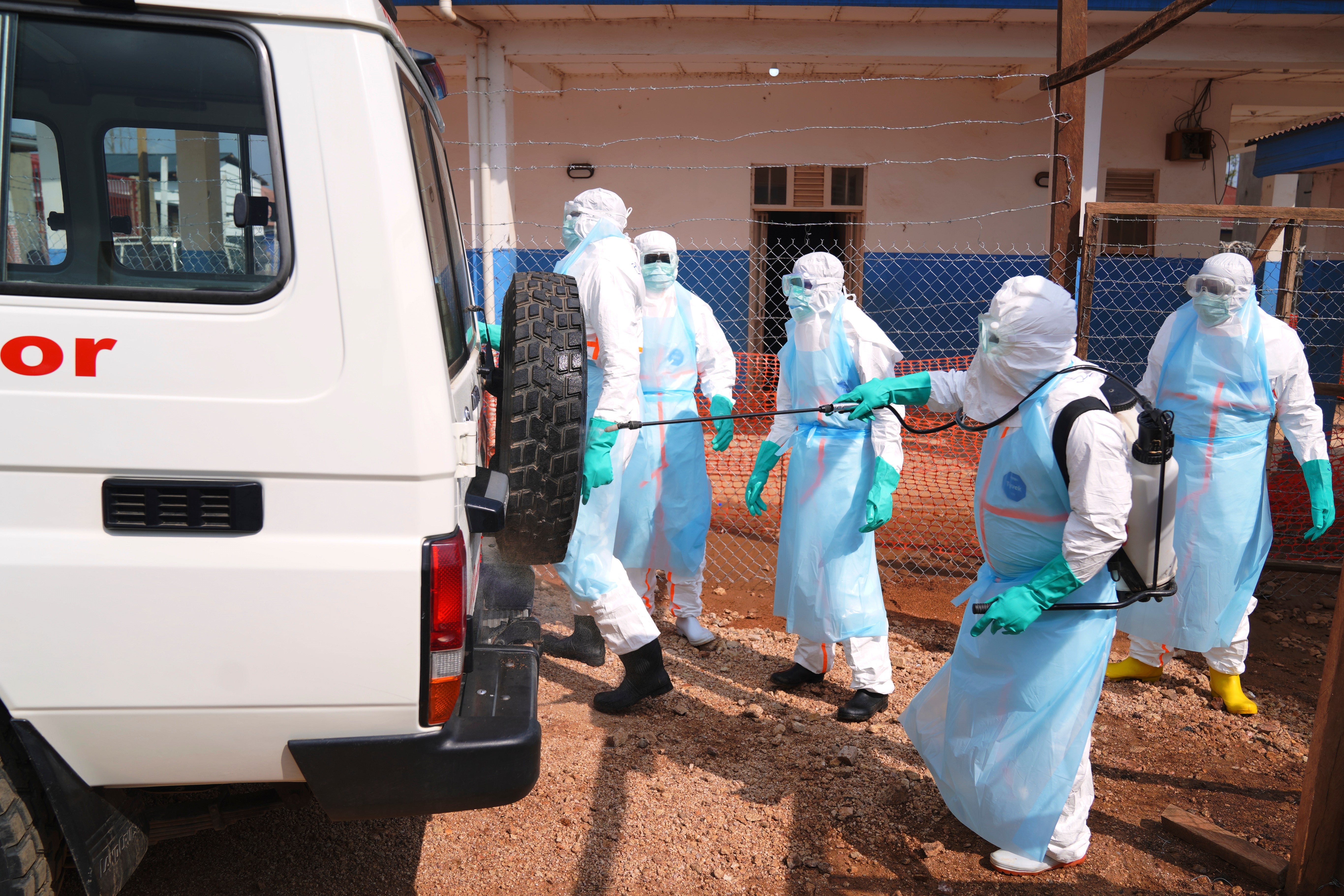 Health workers disinfects an ambulance at Ebola Treatment Center at Bunia General Hospital in Ituri, Congo,