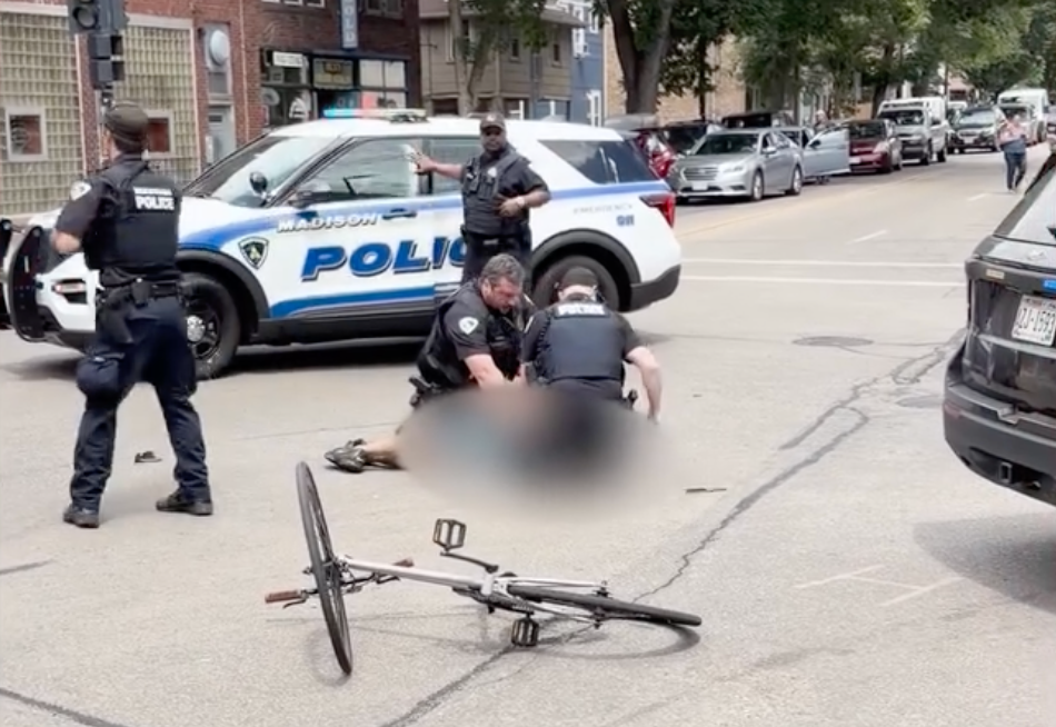 With the victim face down on the ground as blood poured from his head, the officer then placed the man’s hands behind his back. Another officer removed the knife