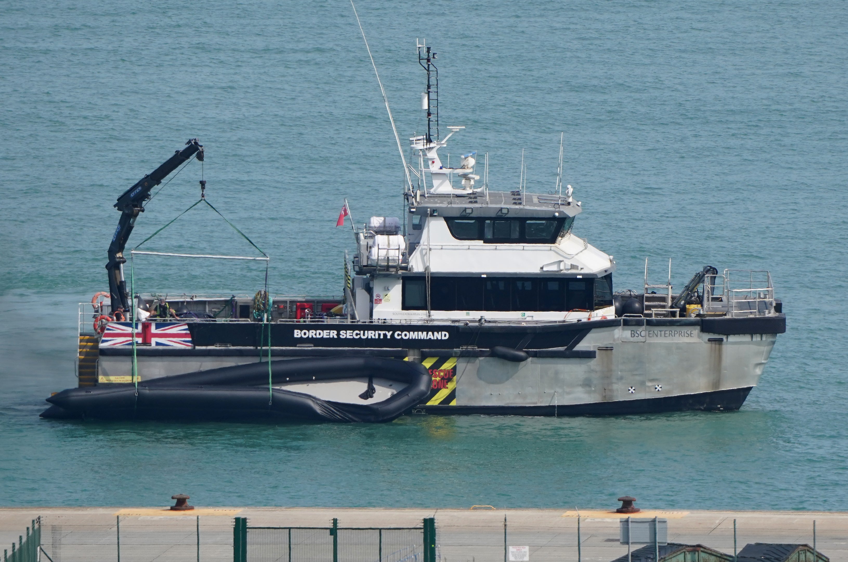 A Border Security Command vessel tows a boat used by a group of people thought to be migrants (Gareth Fuller/PA) (PA Wire)