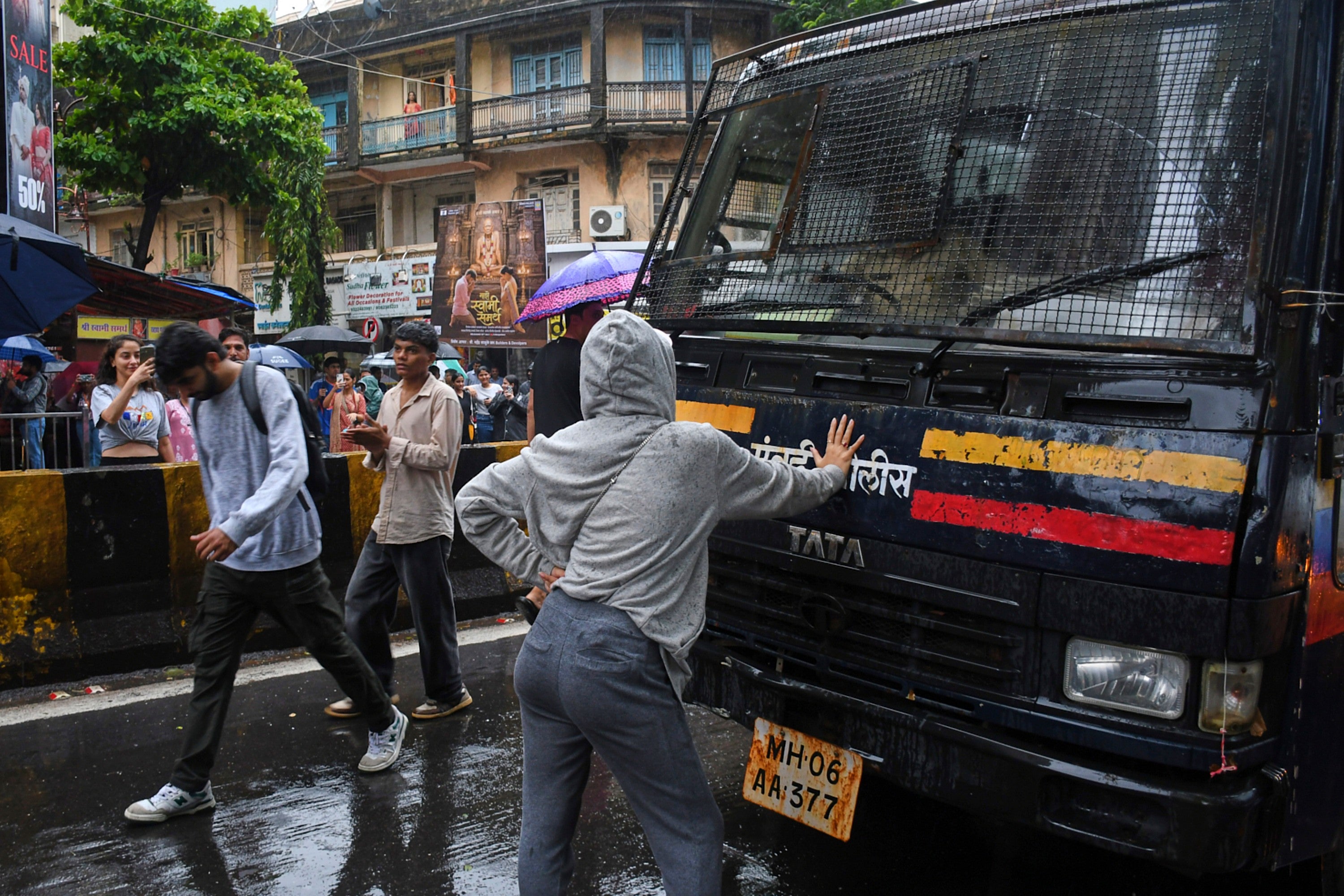 Rhiya Ahir, a model, blocks a police van carrying detained protesters during Cockroach Janta Party's ongoing protest movement in Mumbai ((AP Photo/Ashish Vaishnav))