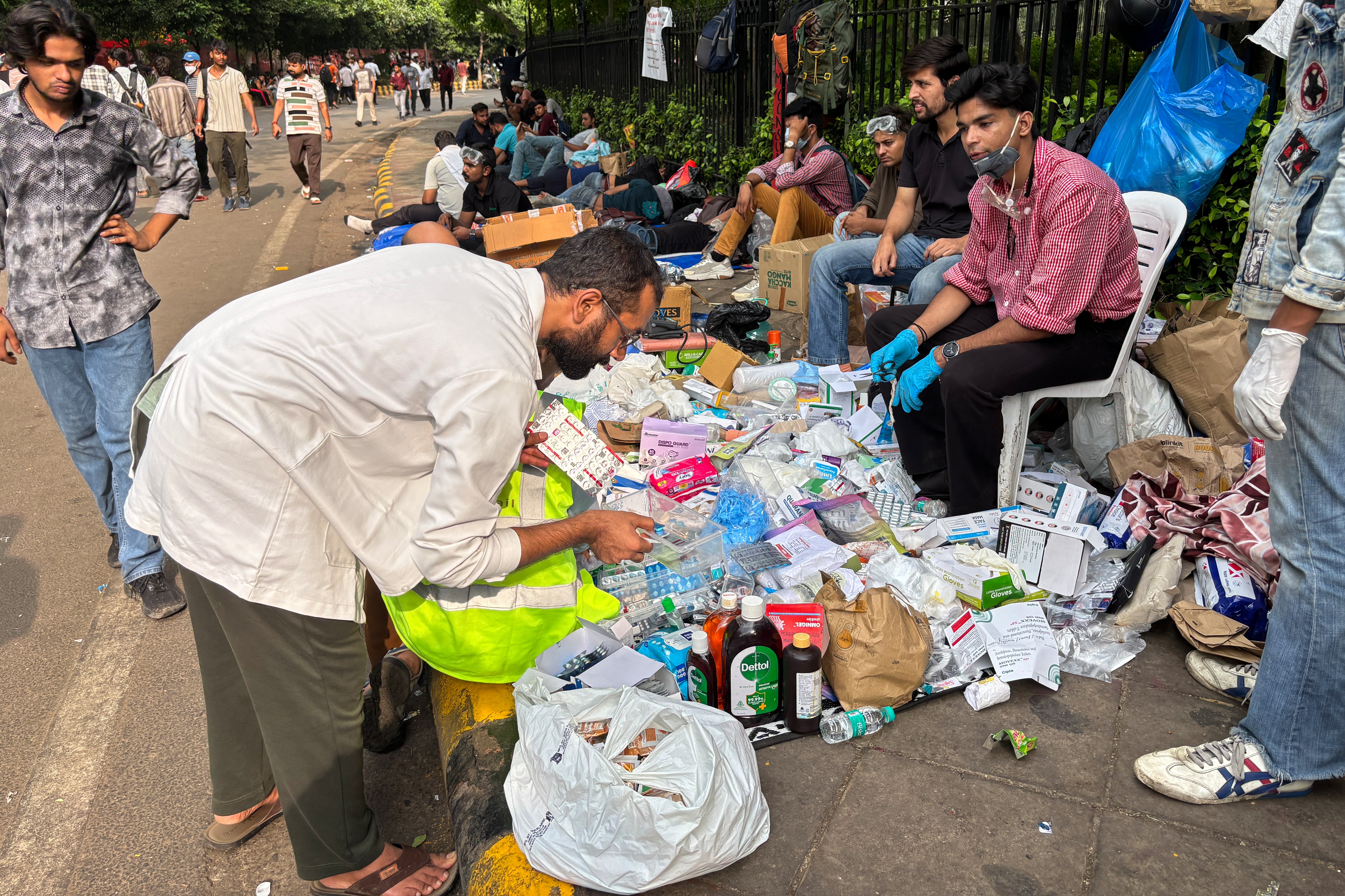 A volunteer doctor sorts strips of medicine at a makeshift stall set up for the protestors during a demonstration demanding educational reforms as part of the Cockroach Janta Party's ongoing protest movement in New Delhi, India (AP)