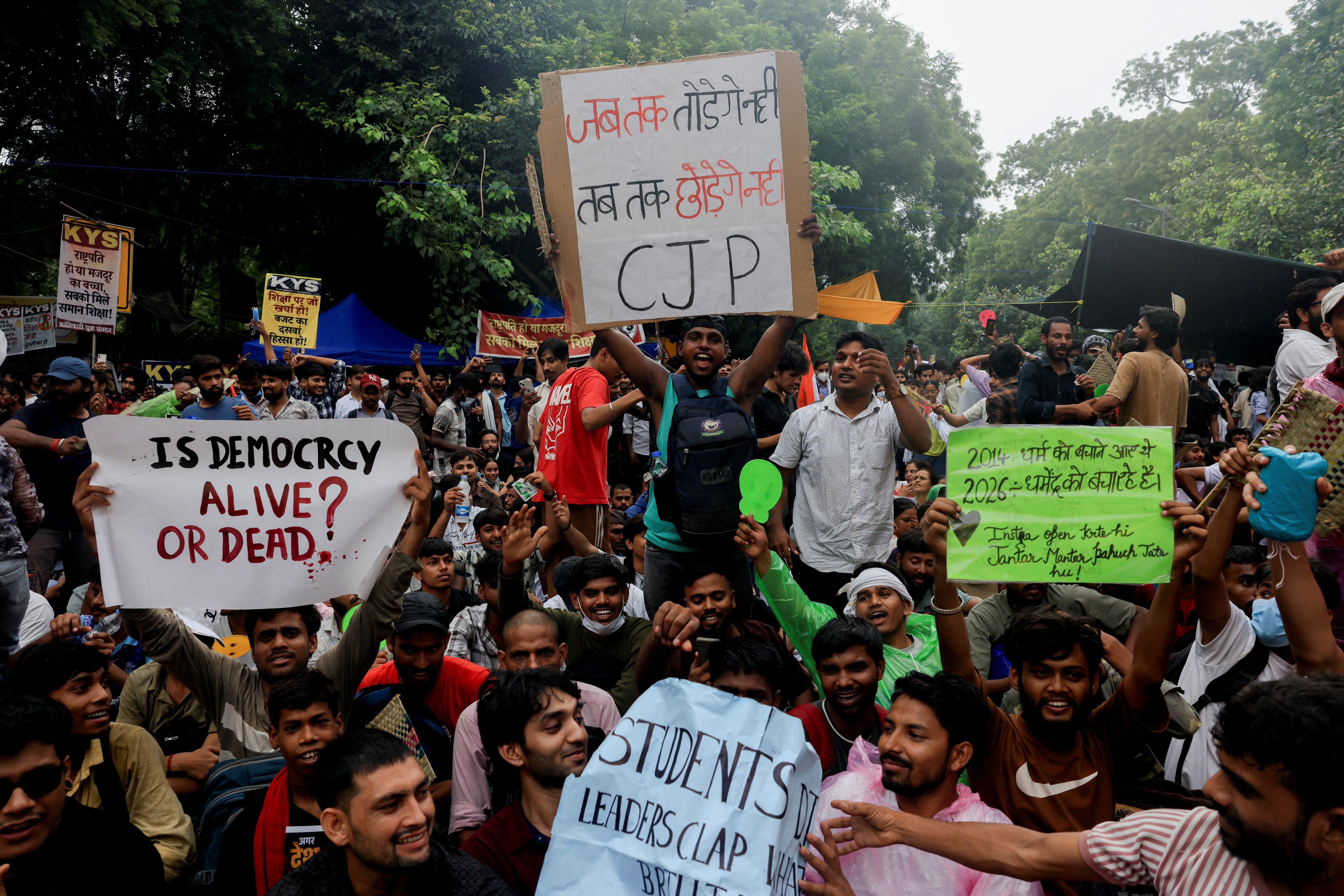 Supporters of India's Cockroach Janta Party hold placards and chant slogans during a protest in Delhi