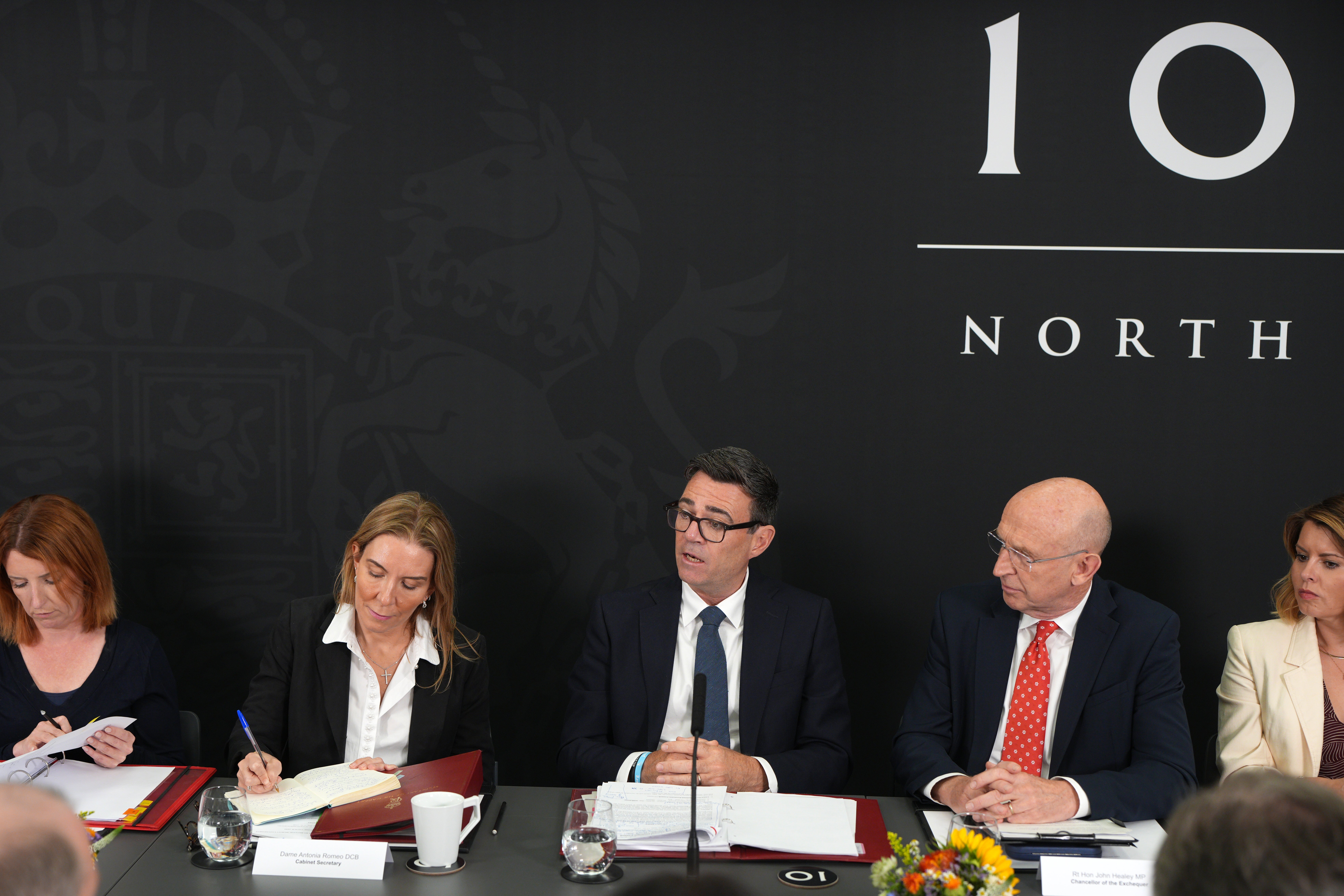 Mr Burnham (centre) is set on splitting his time between London and Manchester
