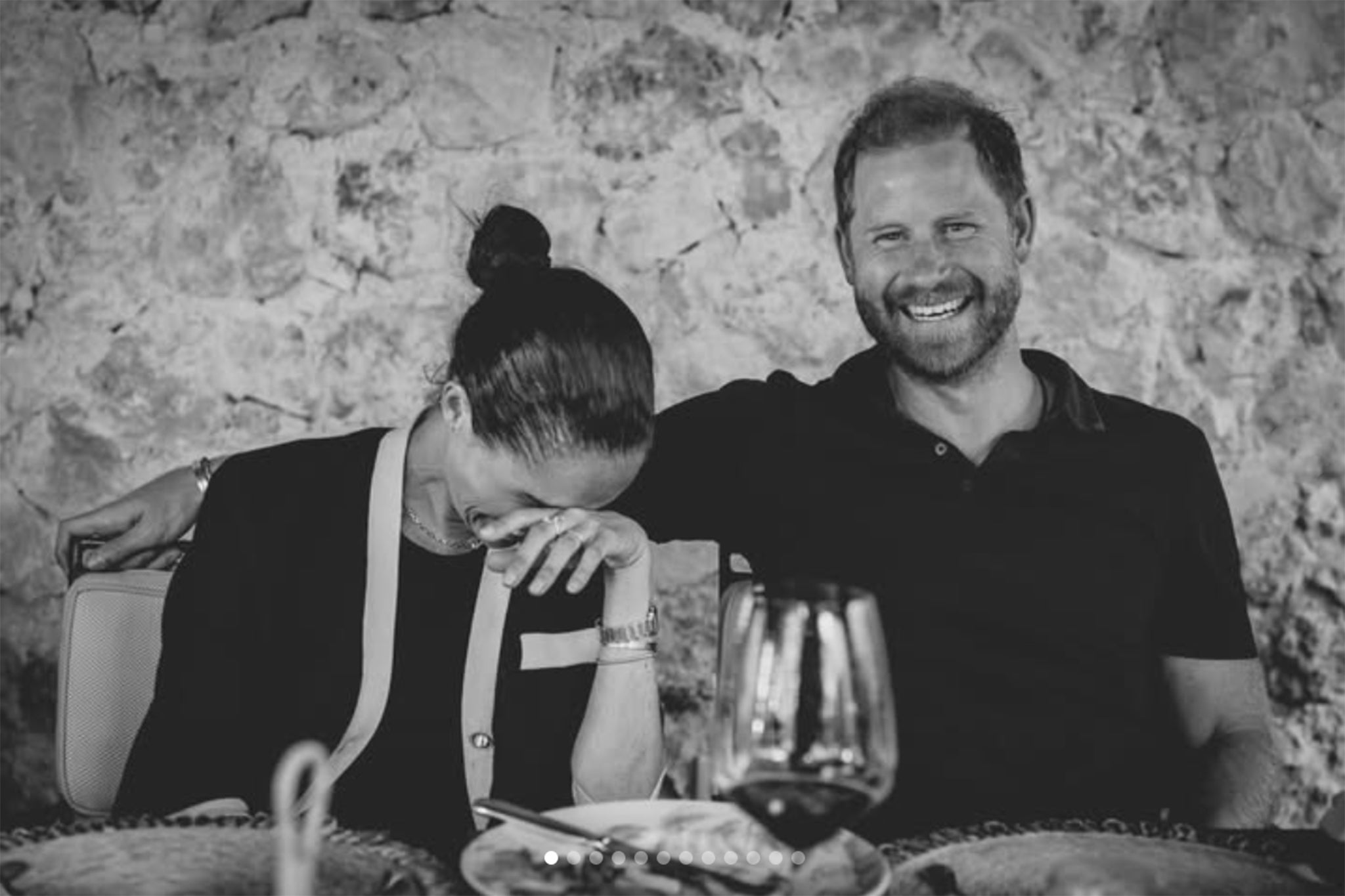 The Duke and Duchess of Sussex are smiling and laughing at dinner