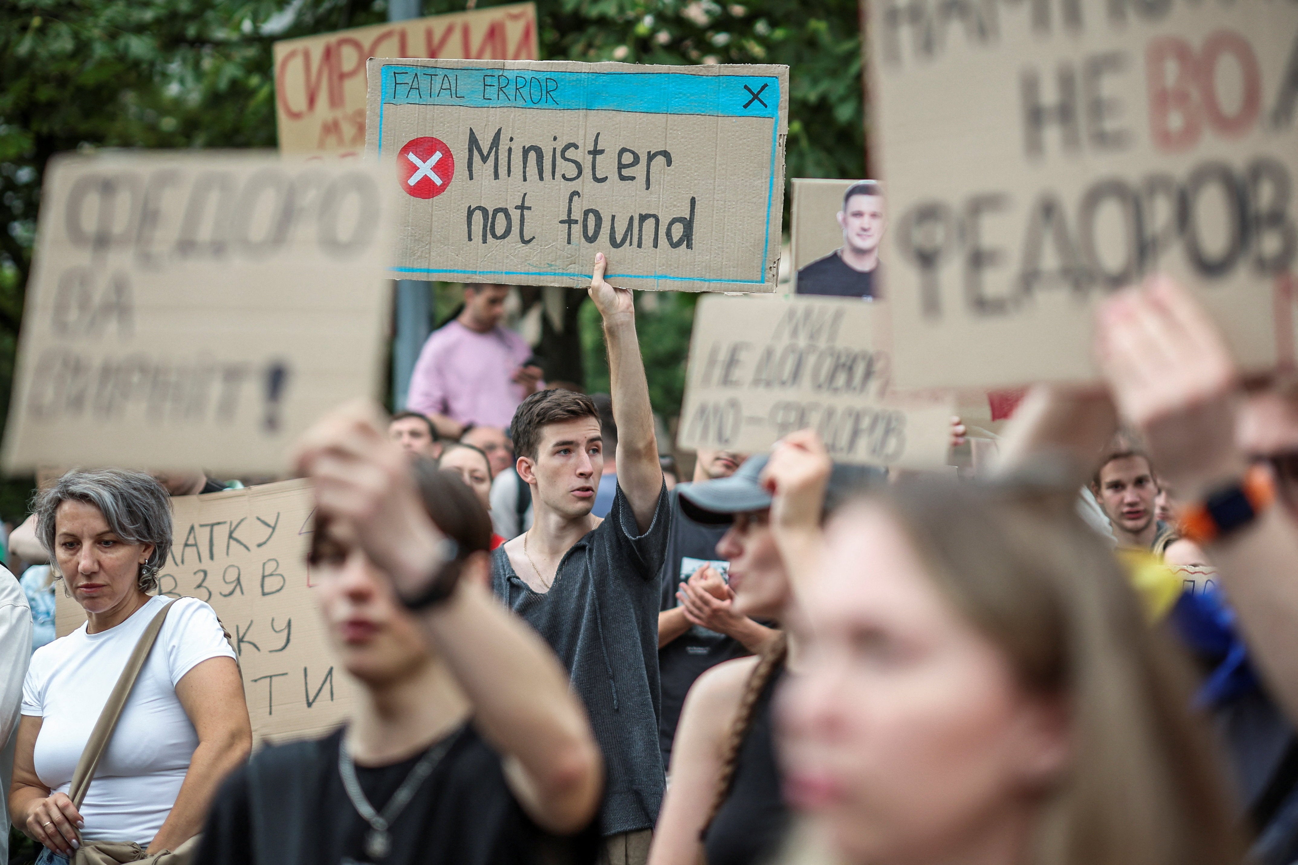 Participants hold signs during a rally to protest against Ukrainian President Volodymyr Zelenskiy's decision to replace Mykhailo Fedorov as Defence Minister, amid Russia's attack on Ukraine, in Kyiv, Ukraine, July 24, 2026. (Reuters)