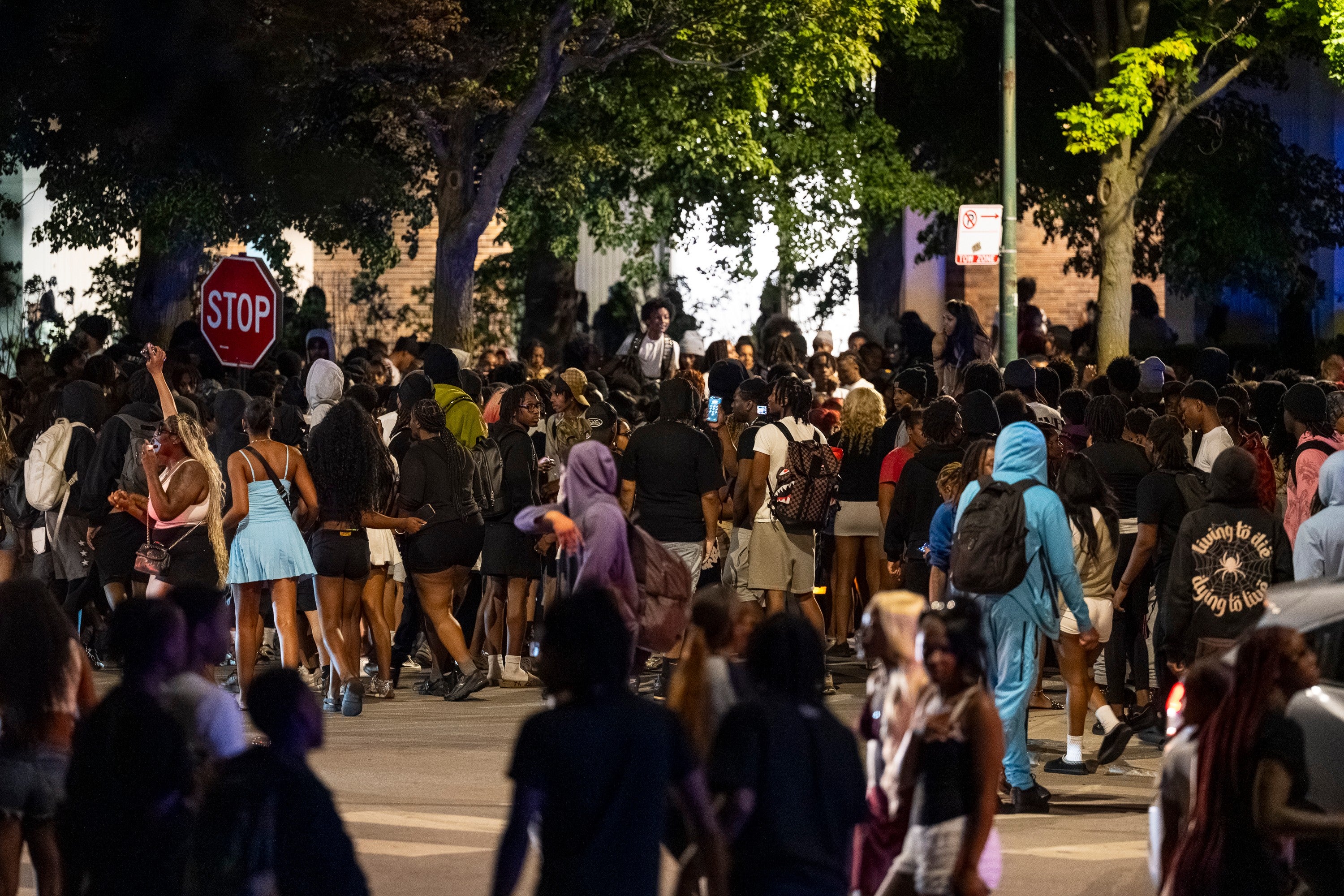 Hundreds of young people gather near the Griffin Museum of Science and Industry in the Hyde Park neighborhood as Chicago police officers attempt to disperse them in May 2025