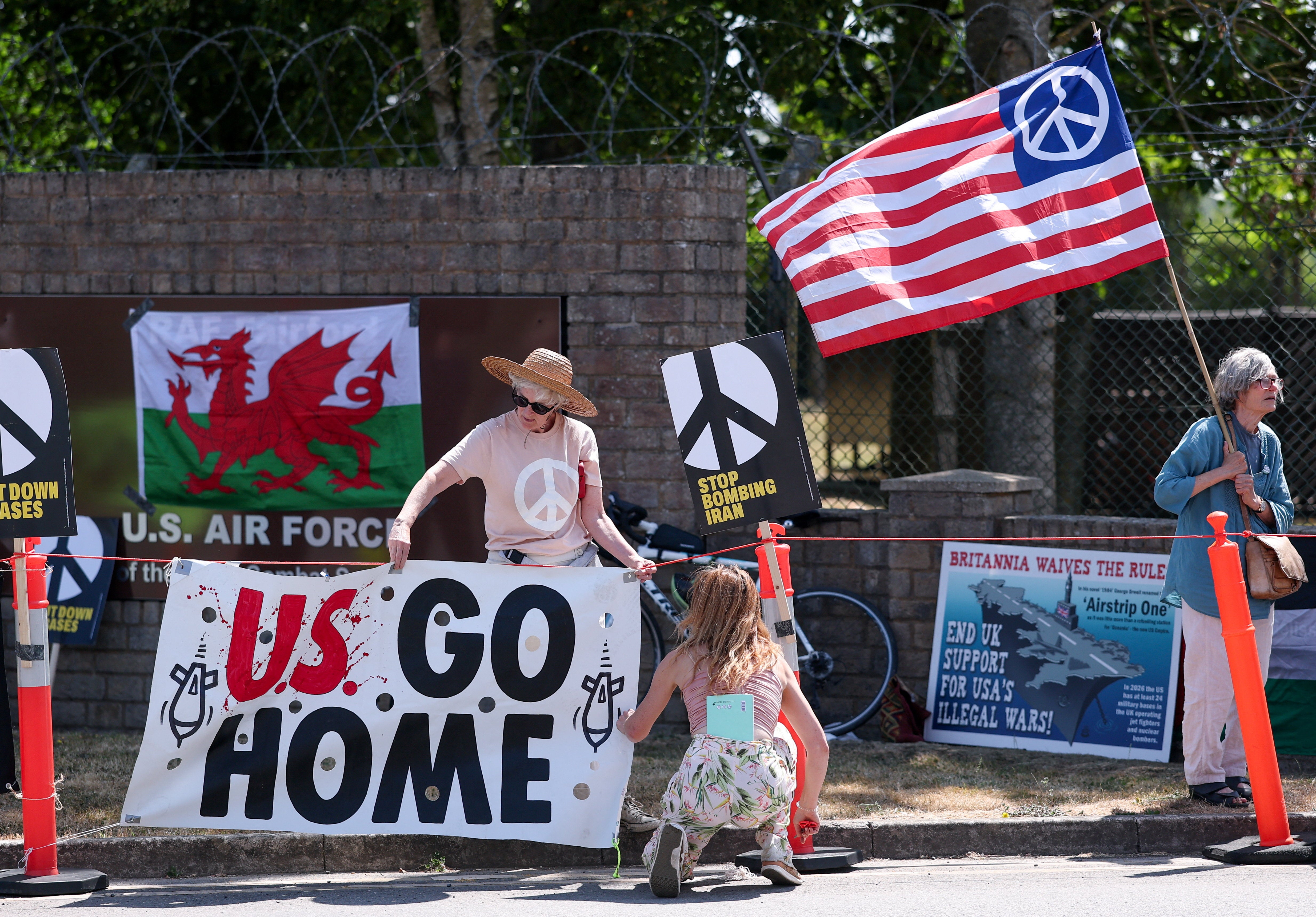 People display a banner with the slogan 'US go home', during an anti-war demonstration outside the main gate of RAF Fairford airbase, which hosts U.S. Air Force (USAF) personnel (Reuters)