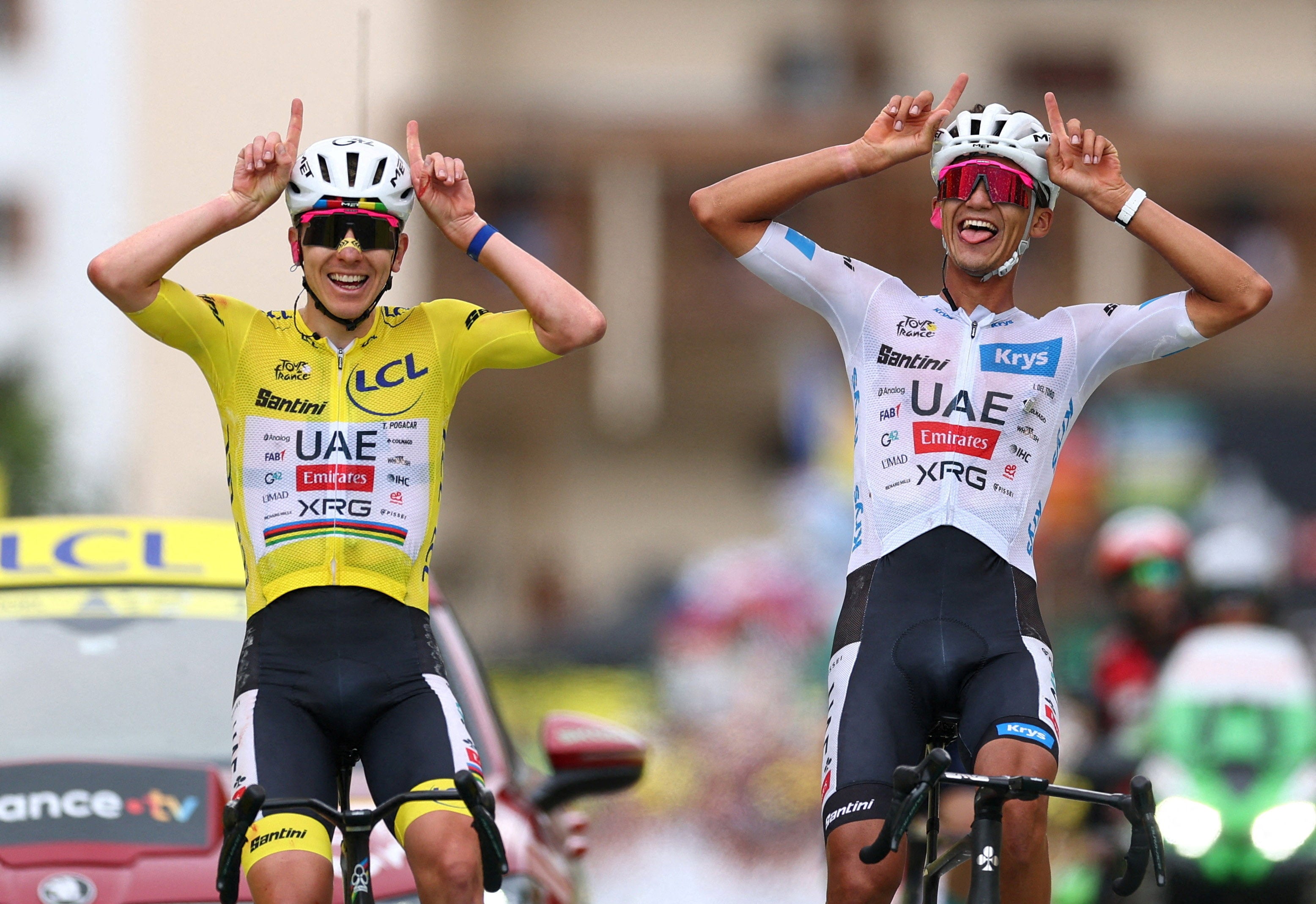 Tadej Pogacar crosses the finish line of stage 20 with teammate Isaac Del Toro