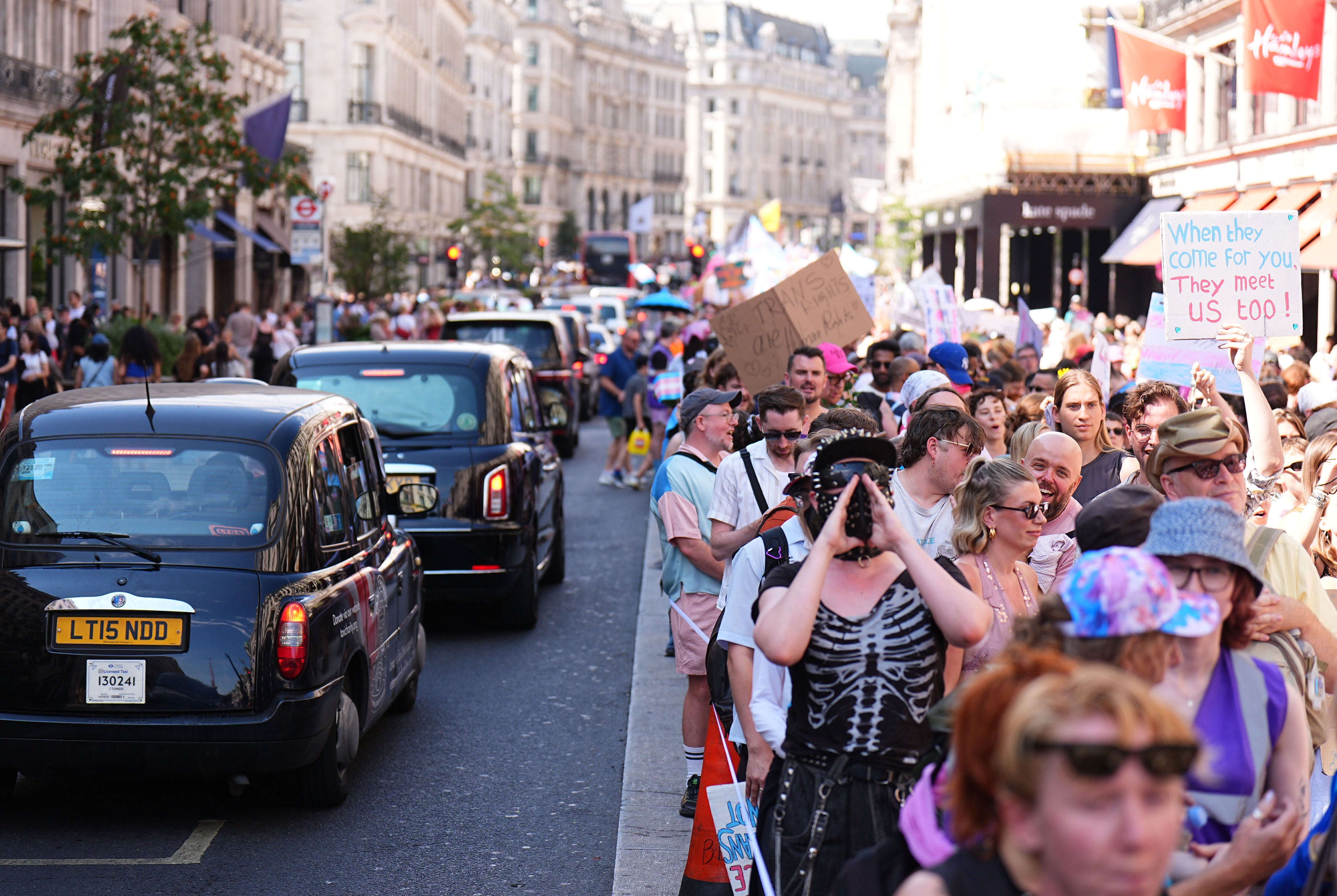 People take part in the London Trans+ Pride march in central London (PA WIRE)