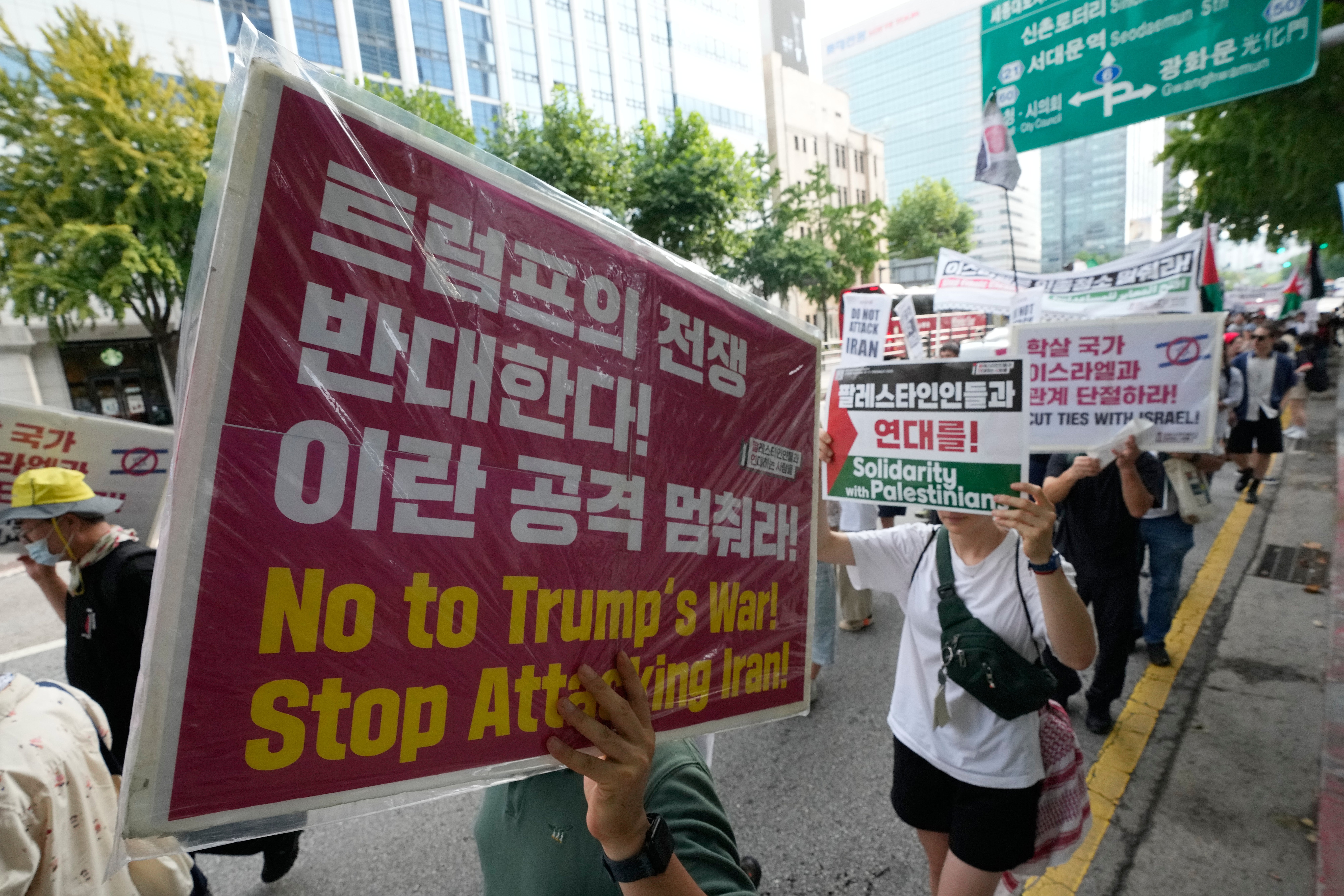 Members of the People in Solidarity with Palestinians march during a rally denouncing the US attacks on Iran in Seoul, South Korea (AP)