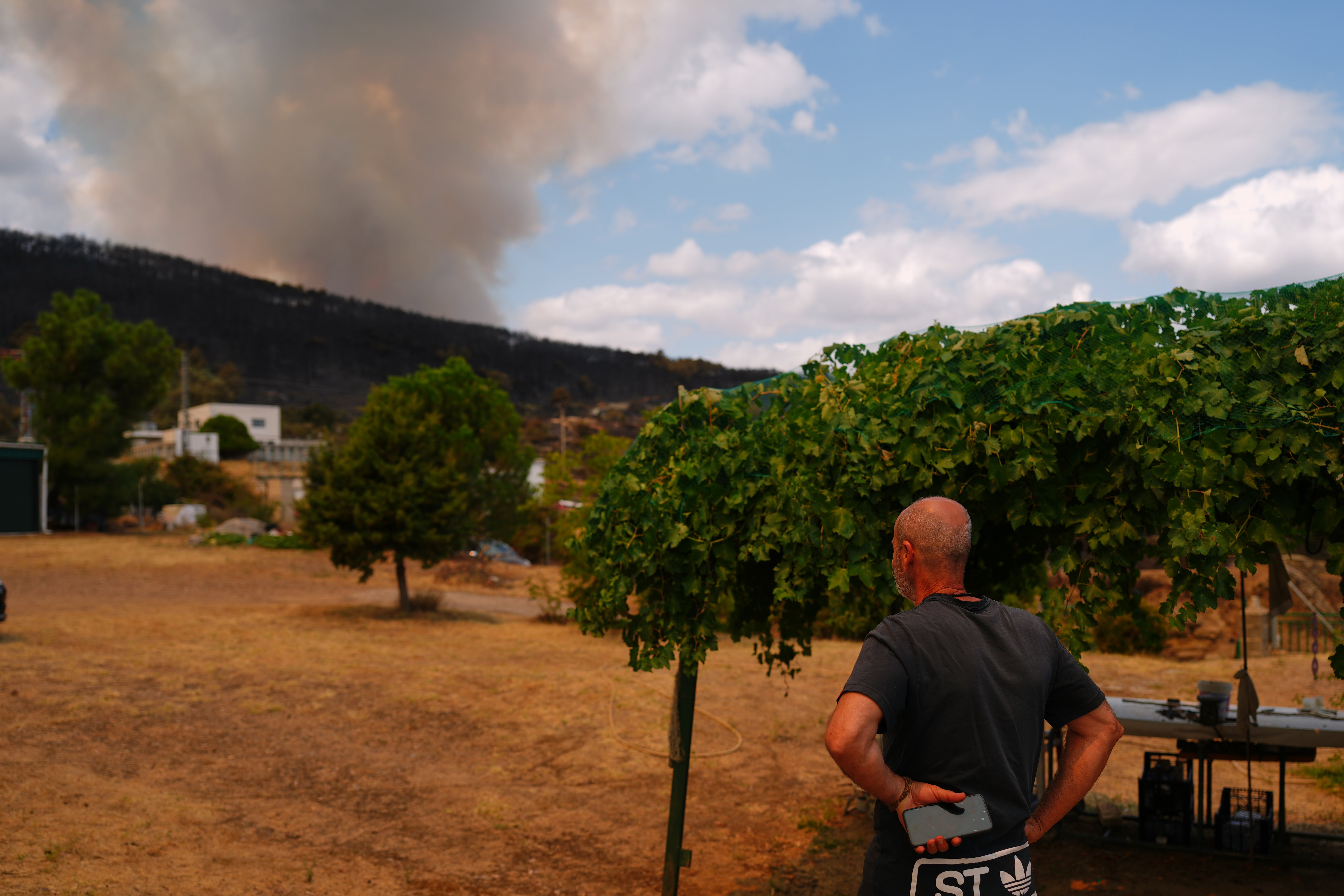 Alberto Garcia watches as a wildfire advances near El Tiemblo, Madrid province, Spain
