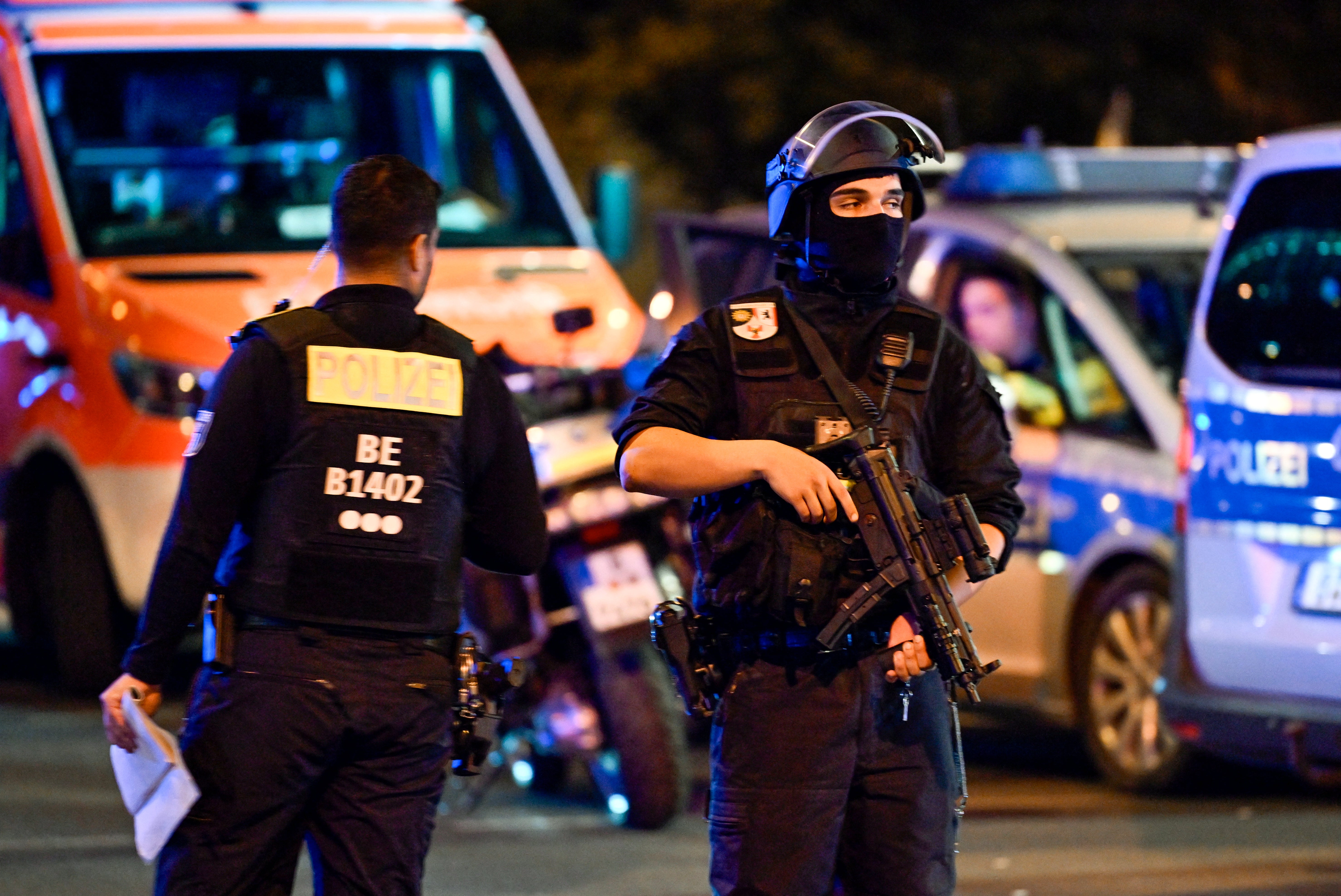 Armed police stand near the scene where one person was killed and around 16 injured after a car struck people on the outskirts of the Christopher Street Day (CSD) parade in Berlin, on 25 July 2026