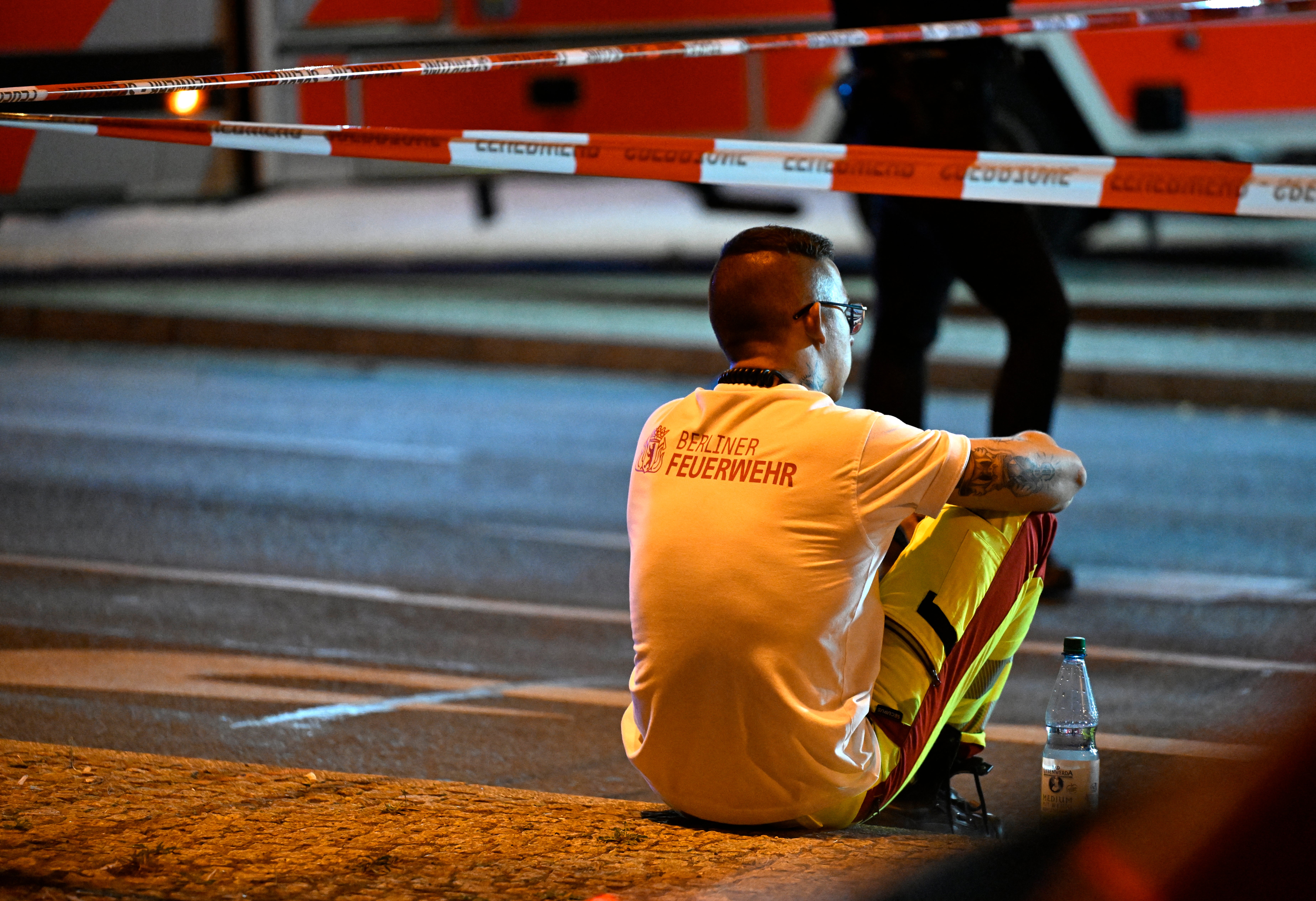 A Berlin firefighter rests near the scene where one person was killed and 16 injured after a car is believed to have hit the crowd on the outskirts of the Christopher Street Day (CSD) parade in Berlin, on 26 July 2026