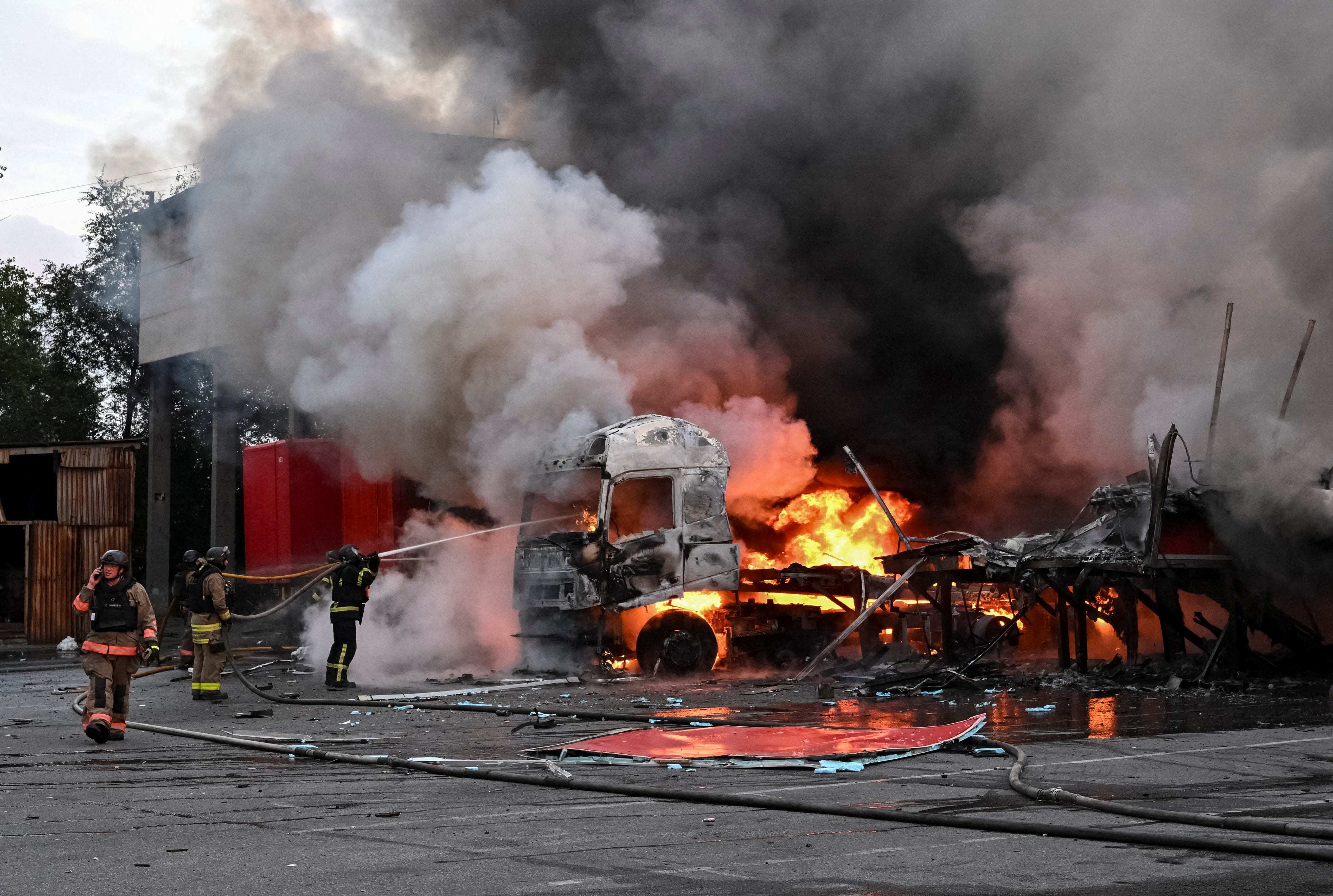 Firefighters work at the site of the postal distribution centre of Nova Post company, hit by a Russian drone strike, amid Russia's attack on Ukraine, in Zaporizhzhia, Ukraine, 25 July 2026