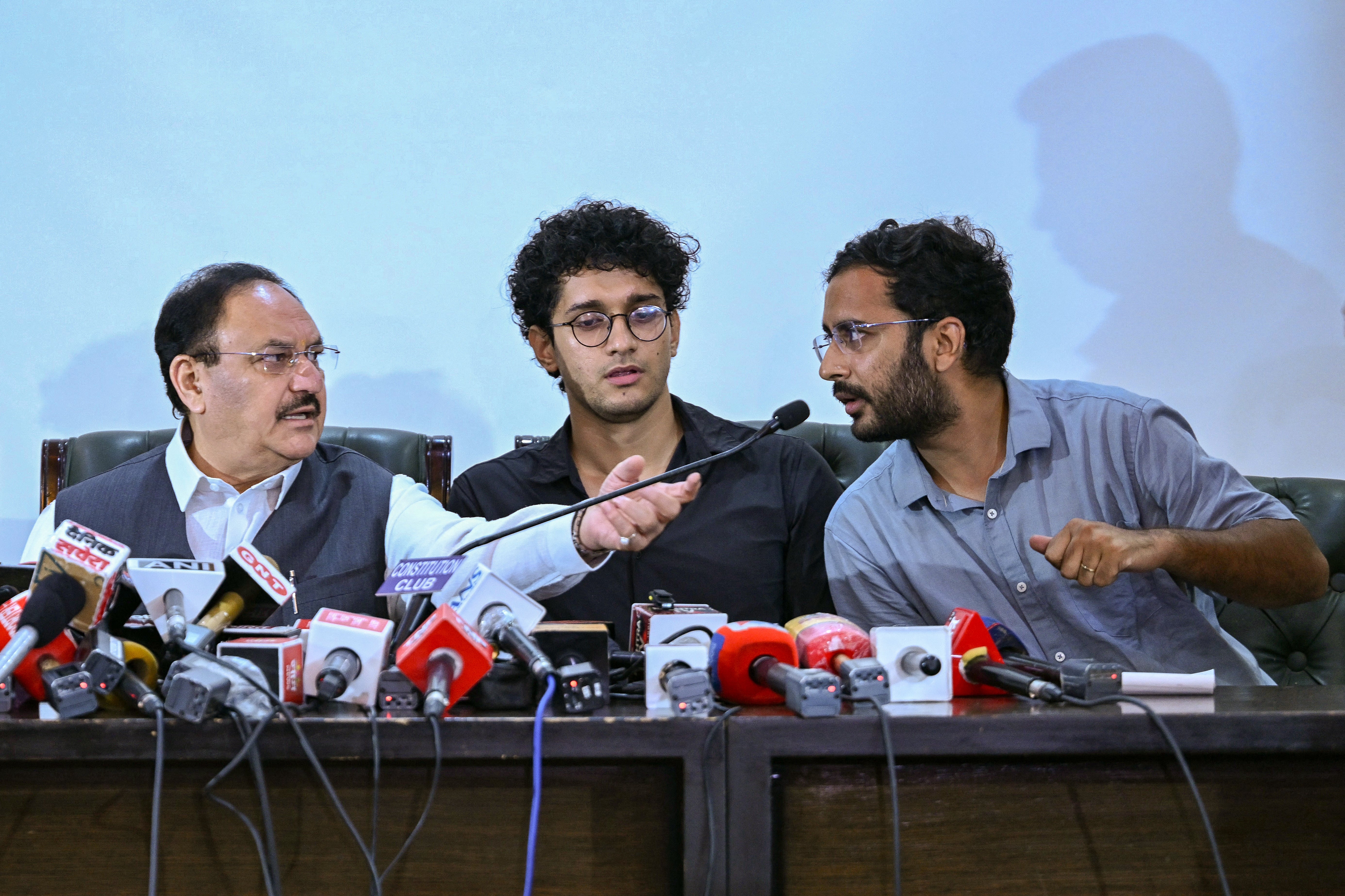 Cockroach Janta Party (CJP) spokespersons Saurav Das (C) and Ashutosh Ranka (R) along with India's Health Minister JP Nadda attend a press conference after their meeting in New Delhi on 25 July 2026