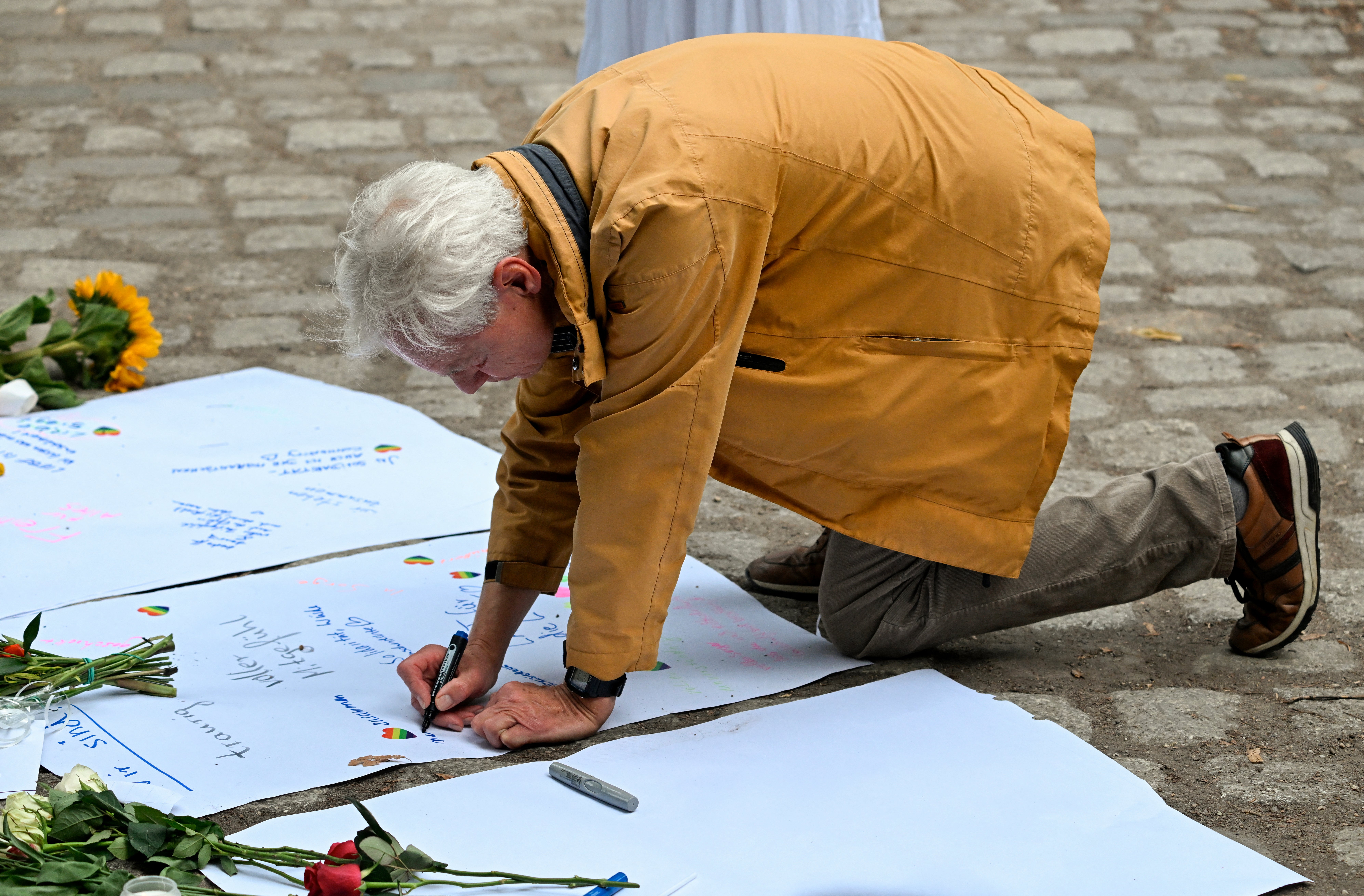 People have left flowers and messages of support at the scene of the attack