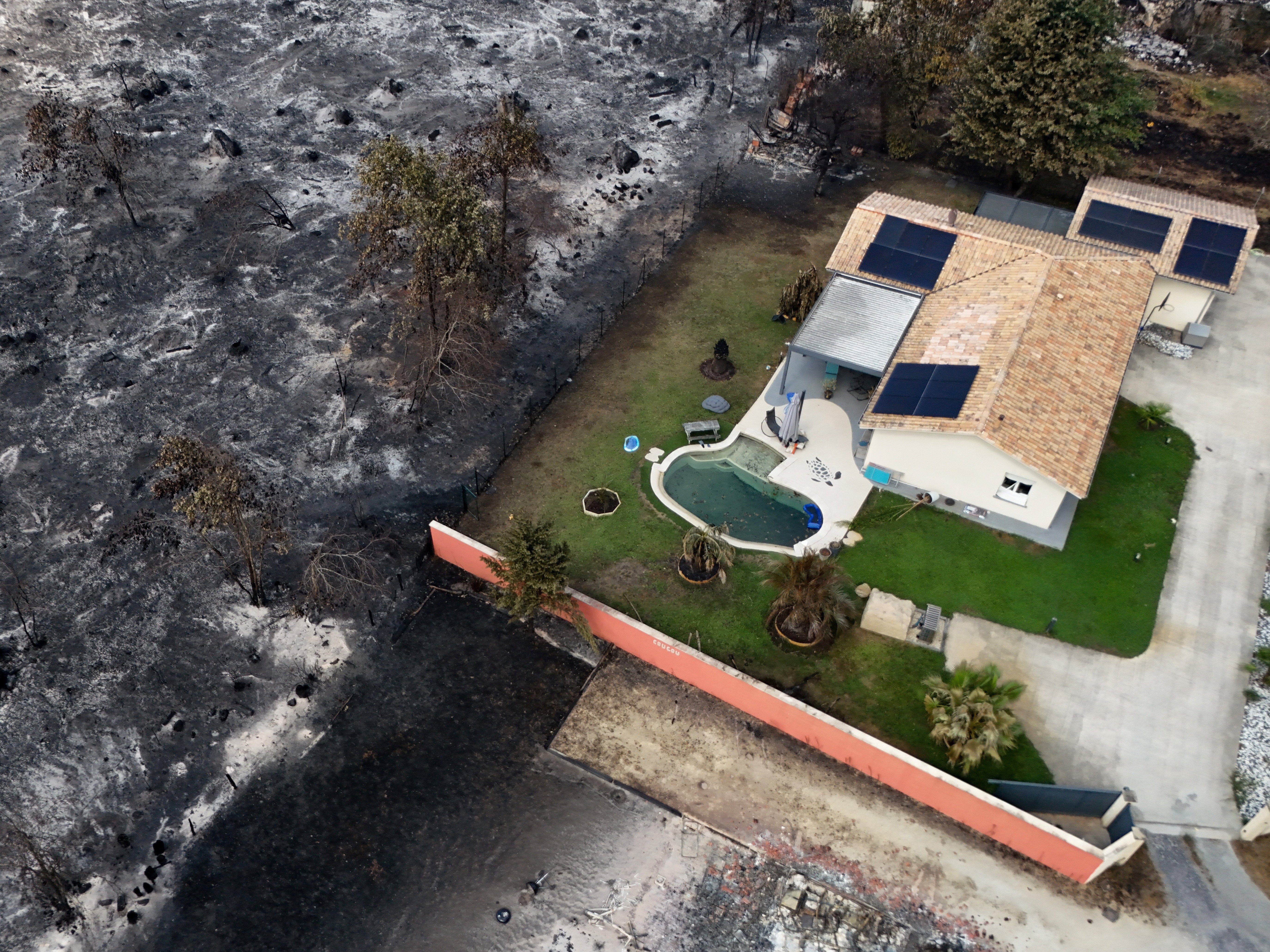 A drone view shows a house that withstood fire damage in an area affected by wildfire, in Le Porge, Gironde, amongst worsening drought conditions following a heatwave and water shortages across much of France, July 26, 2026. (Reuters)