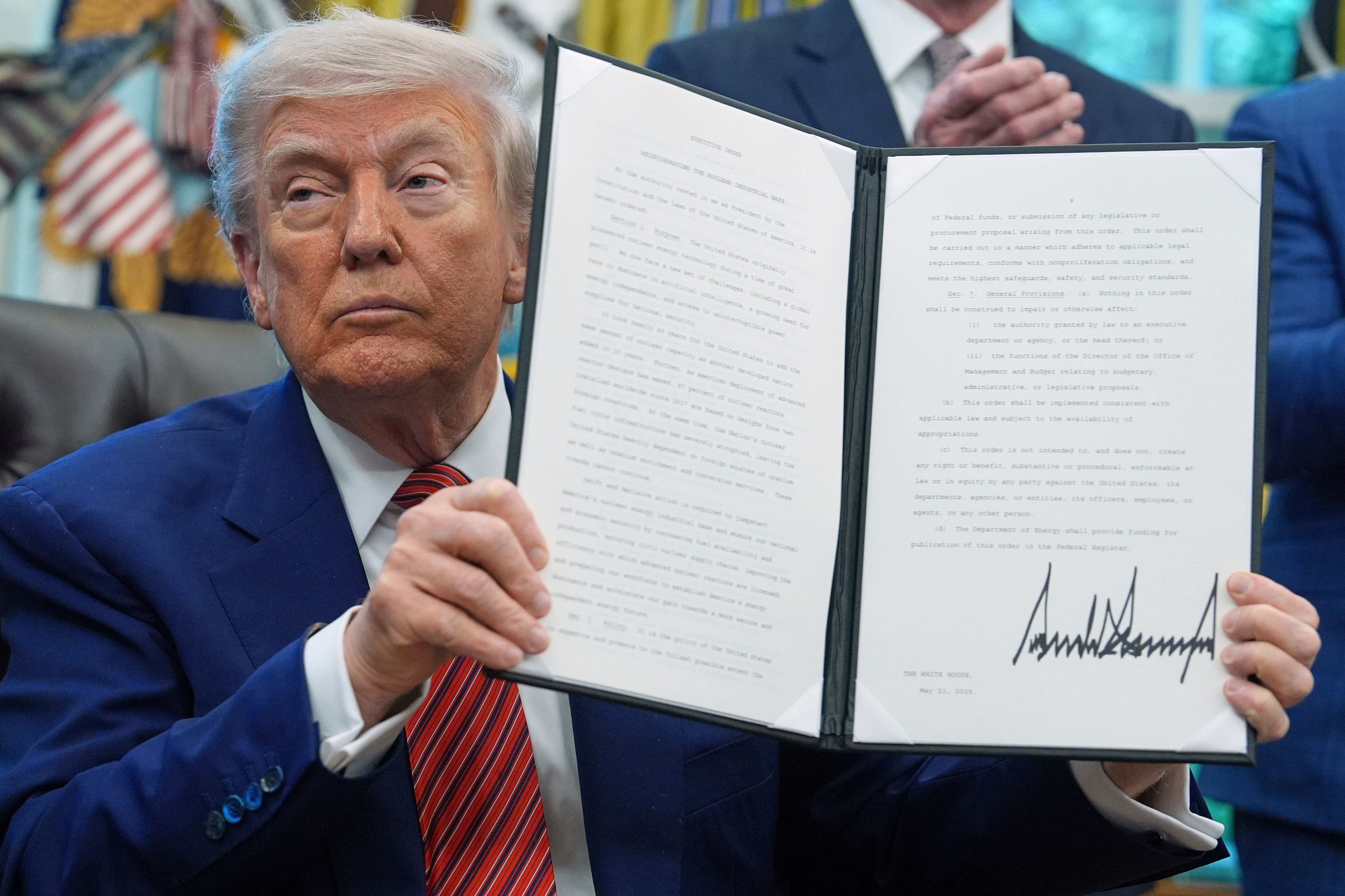 President Donald Trump holds an executive order regarding reinvigorating the nuclear industrial base in the Oval Office of the White House, May 23, 2025