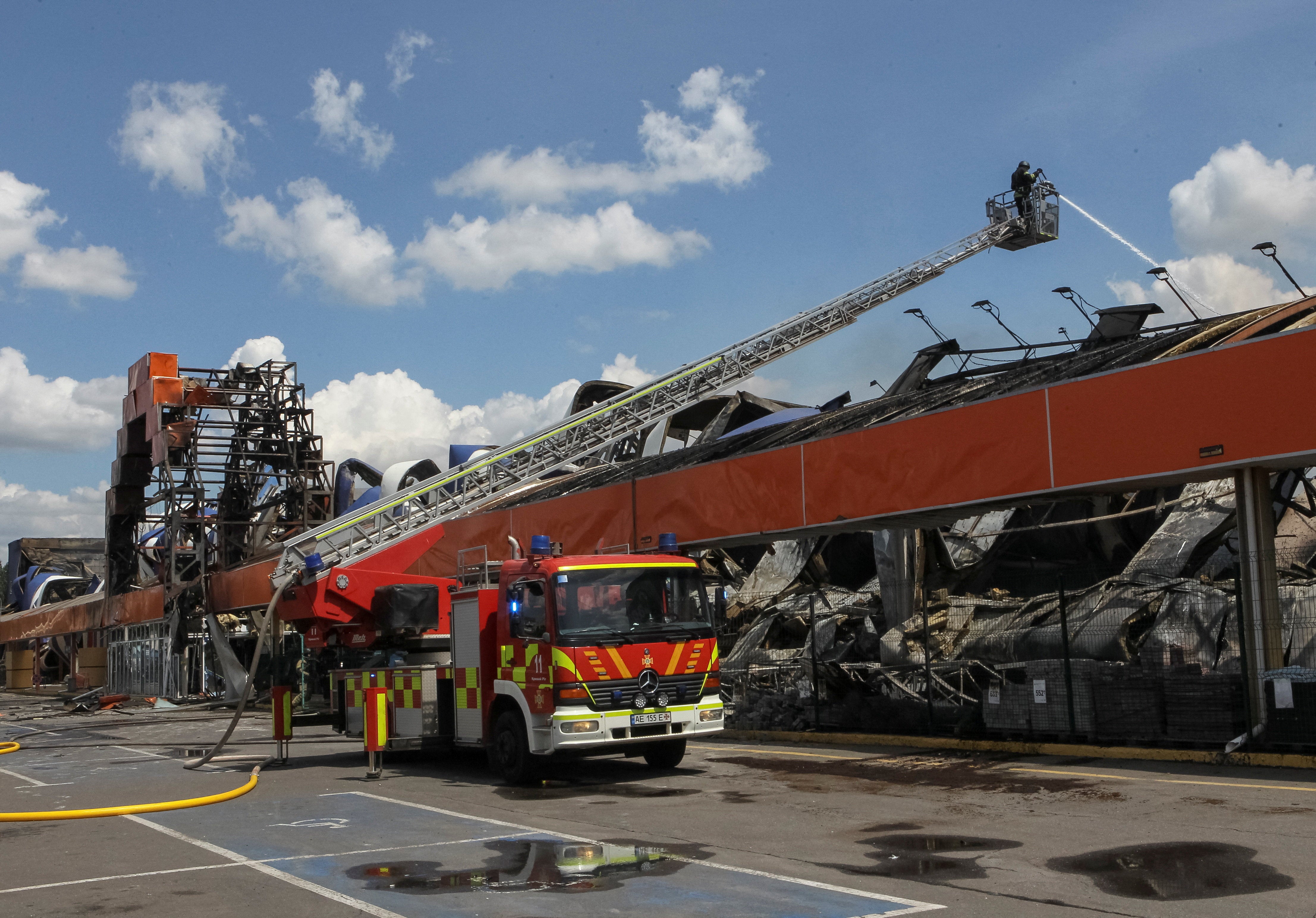 Firefighters work at the site of a household item shopping mall which was hit by a Russian drone strike, amid Russia's attack on Ukraine, in Kryvyi Rih, Dnipropetrovsk region (Reuters)