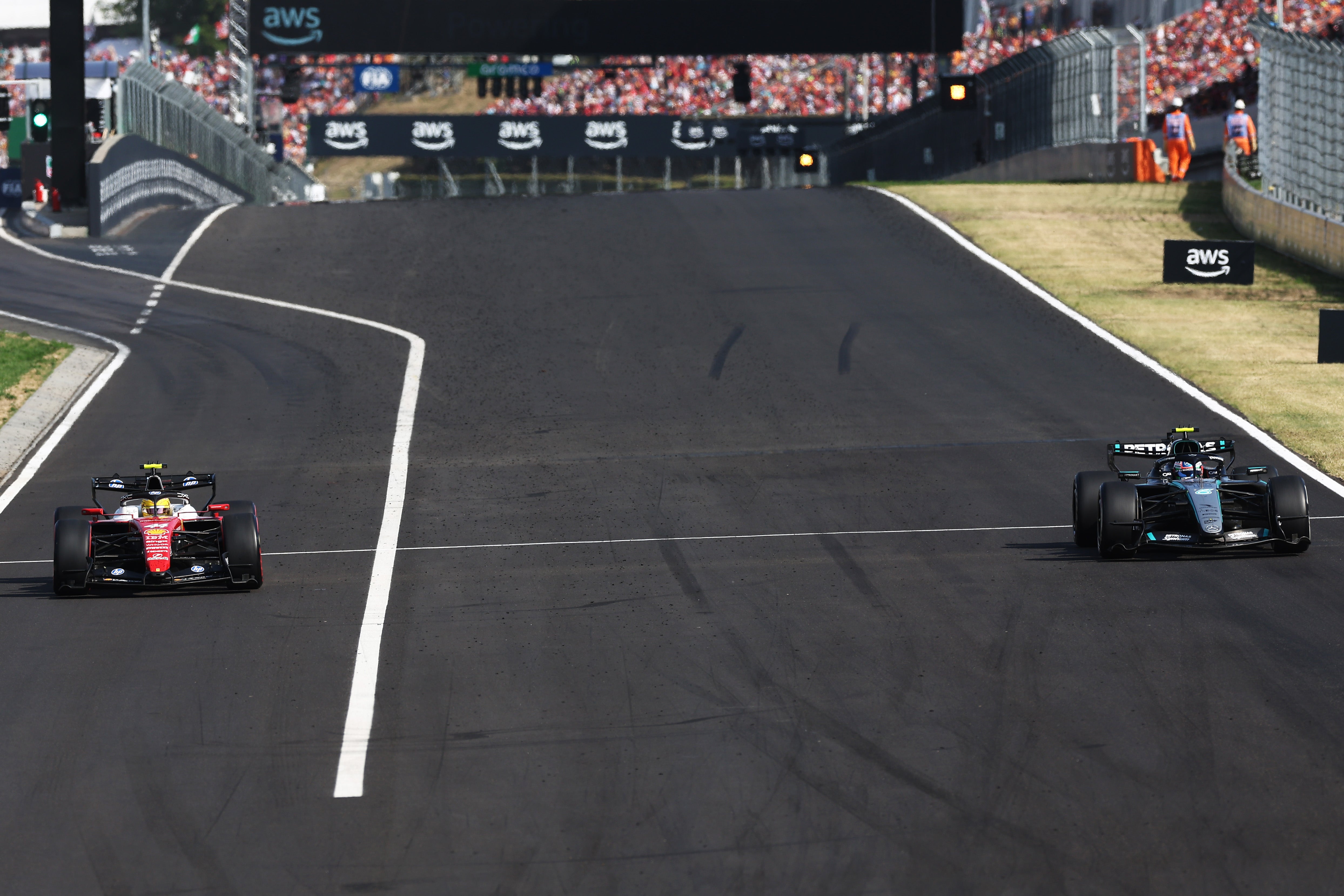 Lewis Hamilton (left) was penalised for speeding in the pit lane (Getty)