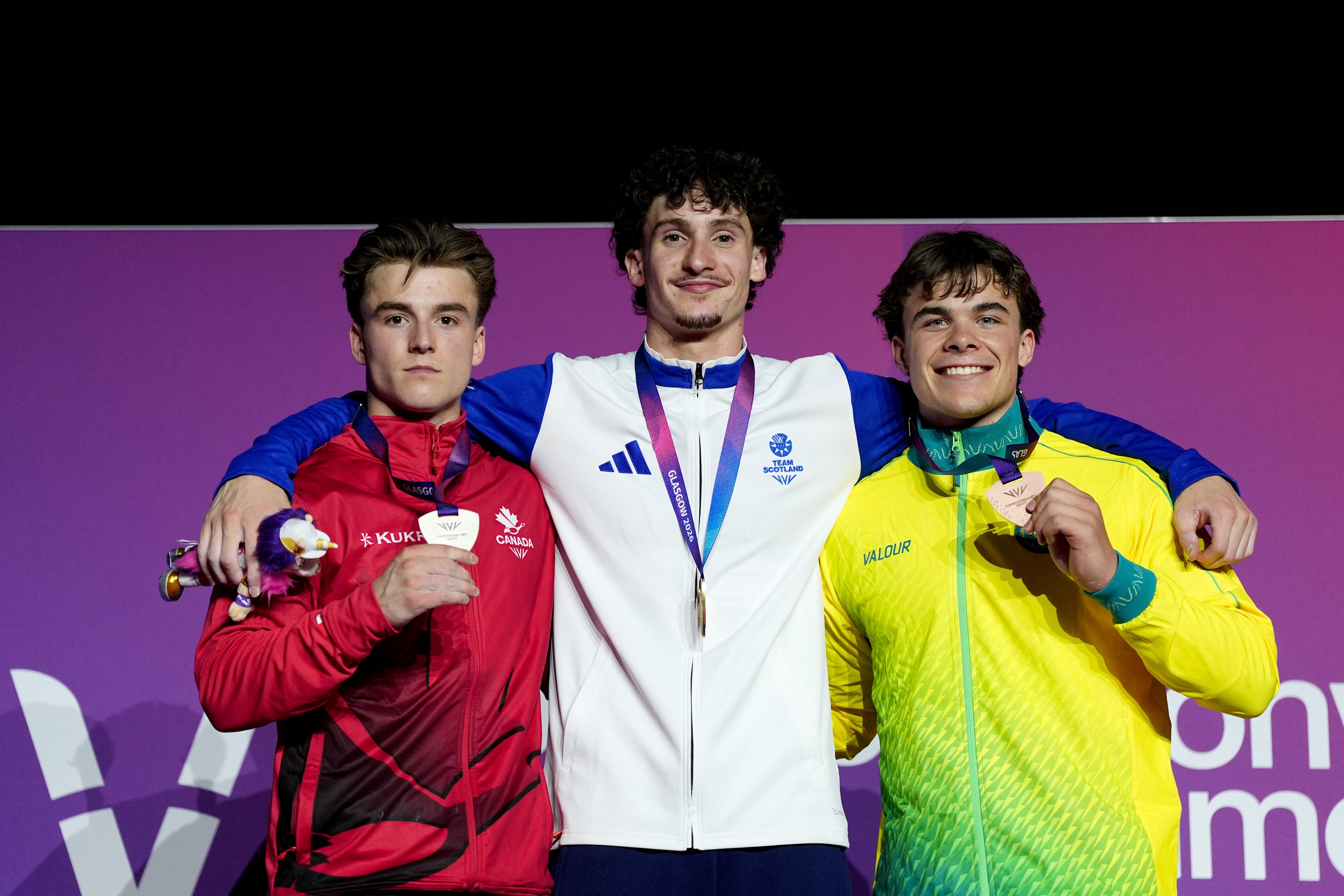 The all-around medallists celebrate on the podium (PA)